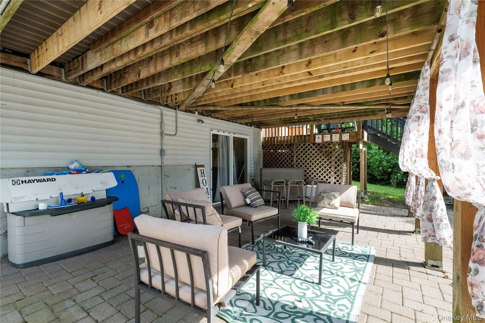 Covered patio area featuring a paver stone surface Covered patio area featuring a paver stone surface