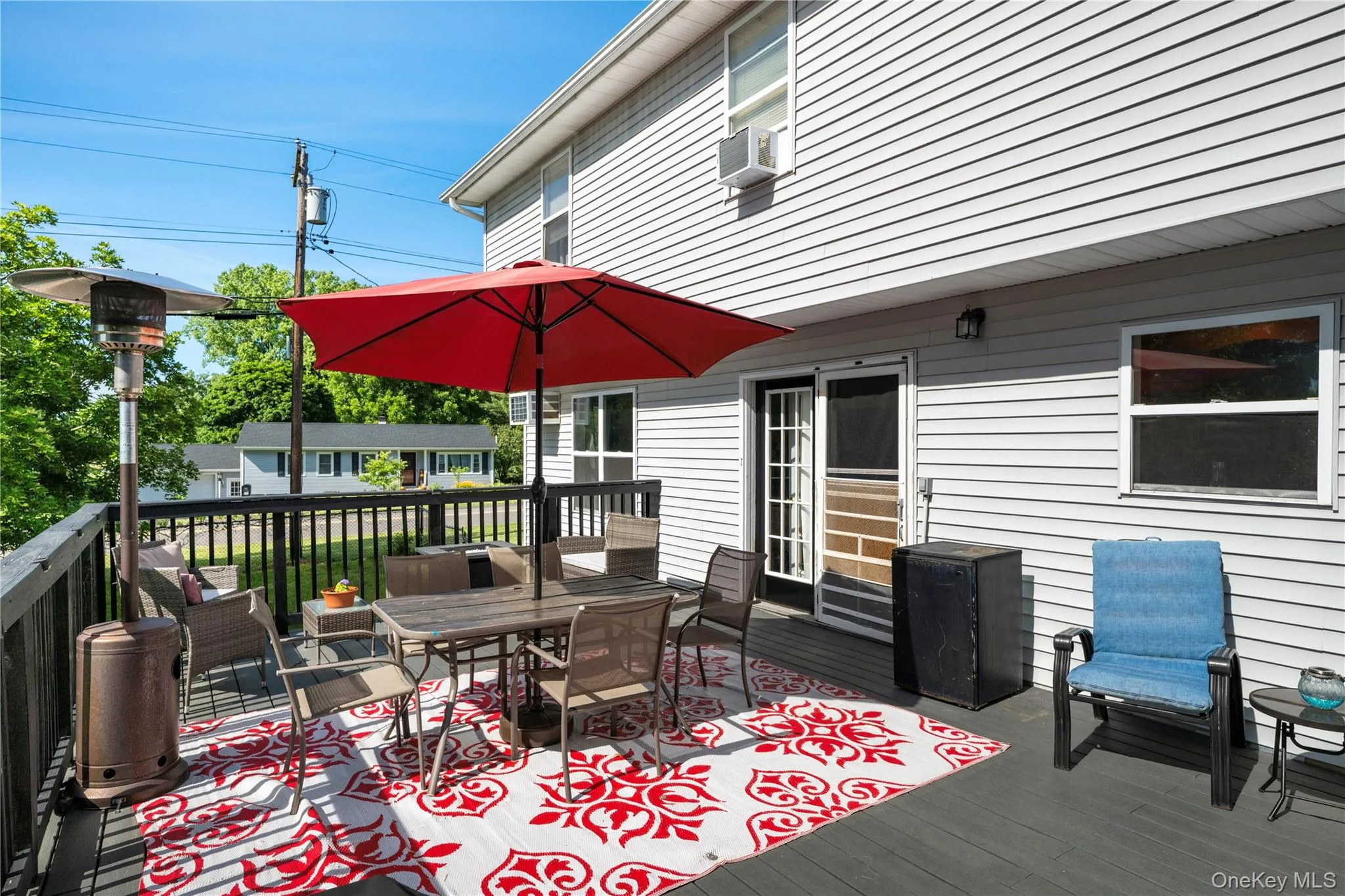 Exterior deck featuring dark composite decking, black railing, and direct access through a white-framed glass door Exterior deck featuring dark composite decking, black railing, and direct access through a white-framed glass door