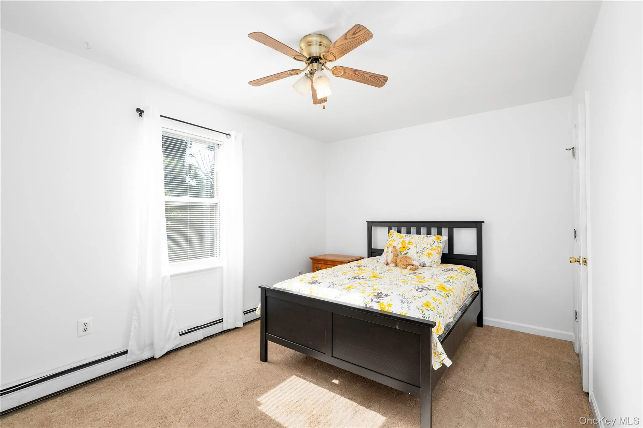 Bright room featuring a window with white blinds, neutral carpeting, and a ceiling fan with integrated lighting Bright room featuring a window with white blinds, neutral carpeting, and a ceiling fan with integrated lighting