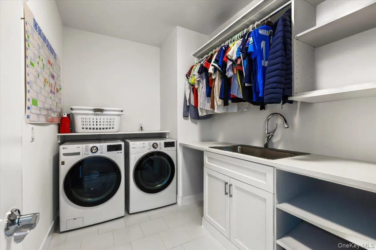 Conveniently located second floor laundry room with linen closet and sink. Conveniently located second floor laundry room with linen closet and sink.