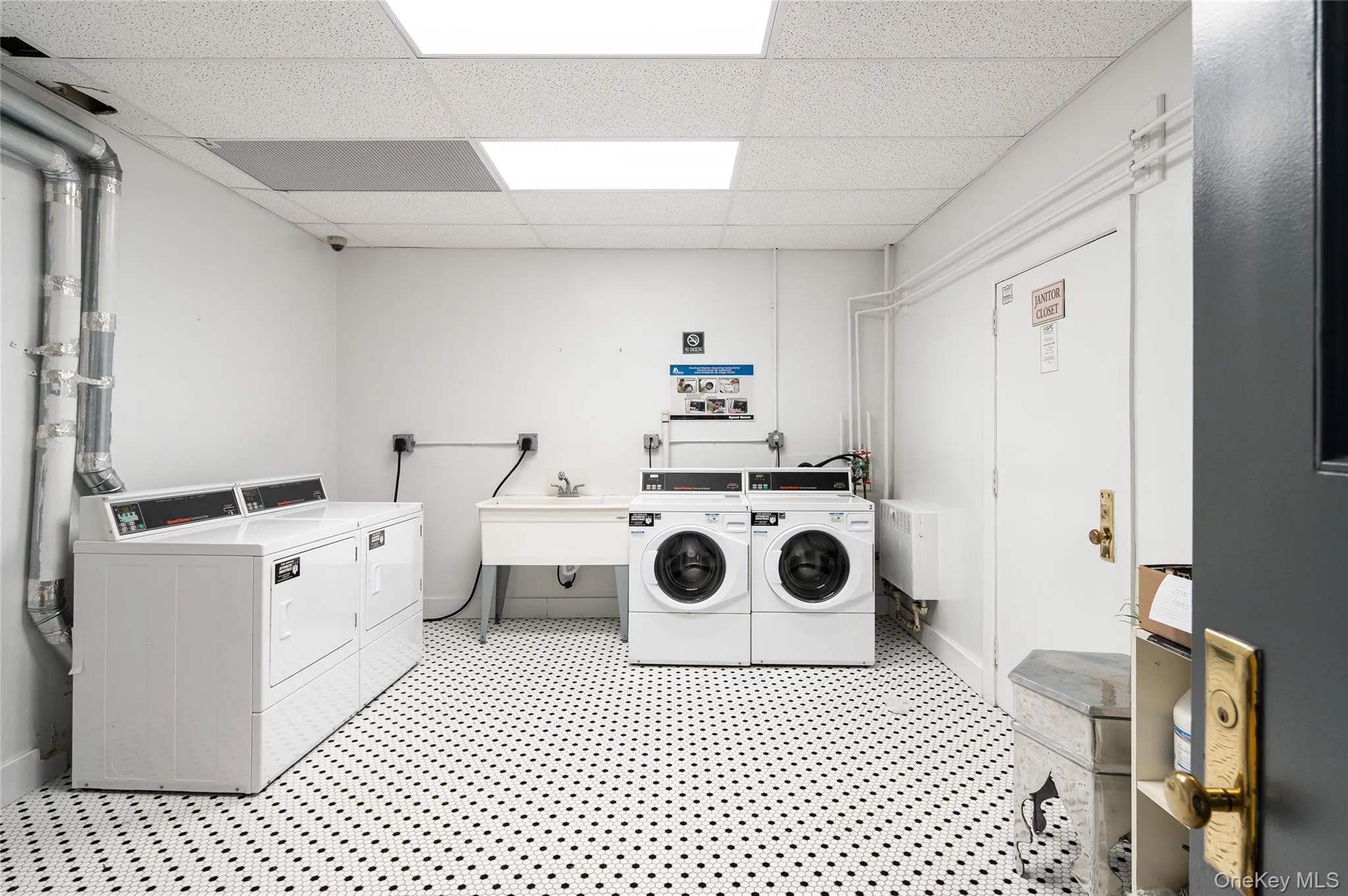 Shared laundry featuring a drop ceiling and separate washer and dryer Shared laundry featuring a drop ceiling and separate washer and dryer