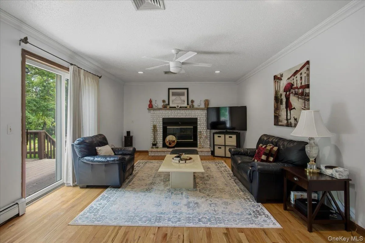 Family room with fireplace and sliding doors to outdoor deck Family room with fireplace and sliding doors to outdoor deck