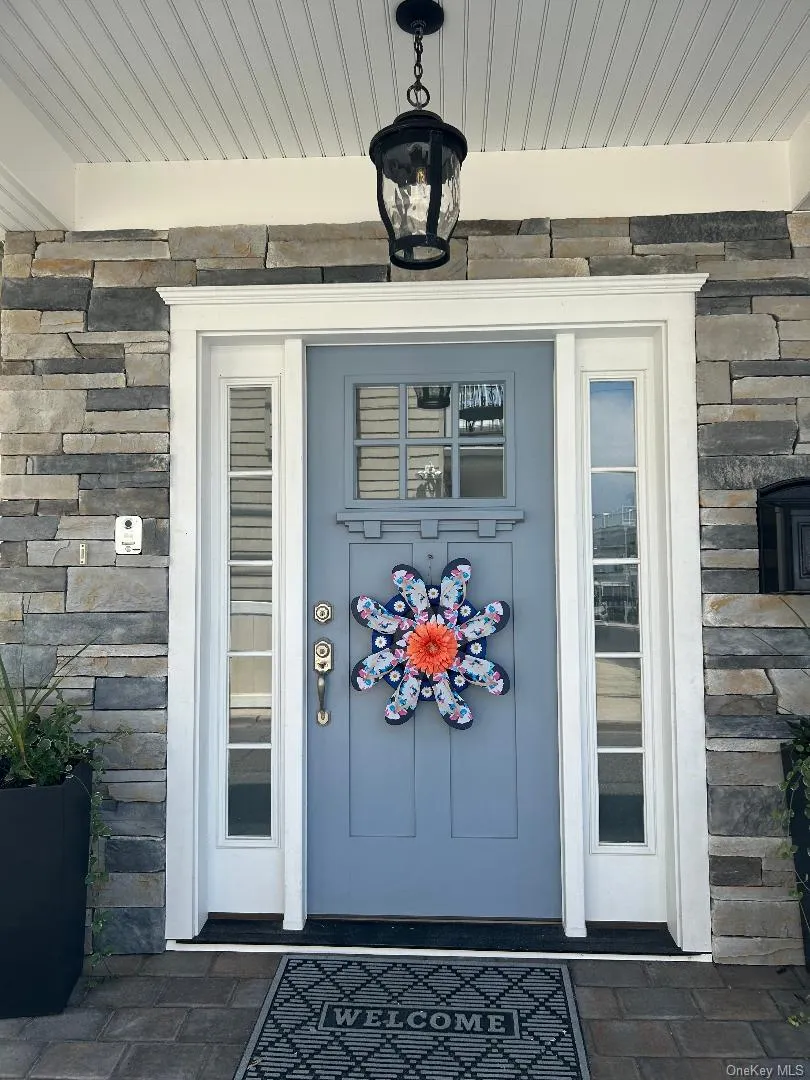 View of exterior entry featuring stone siding View of exterior entry featuring stone siding