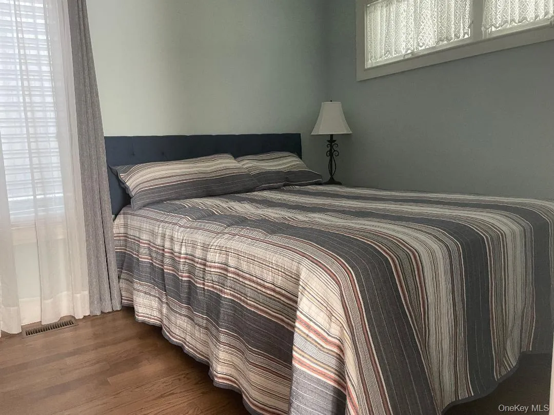 Bedroom with dark wood-style flooring Bedroom with dark wood-style flooring