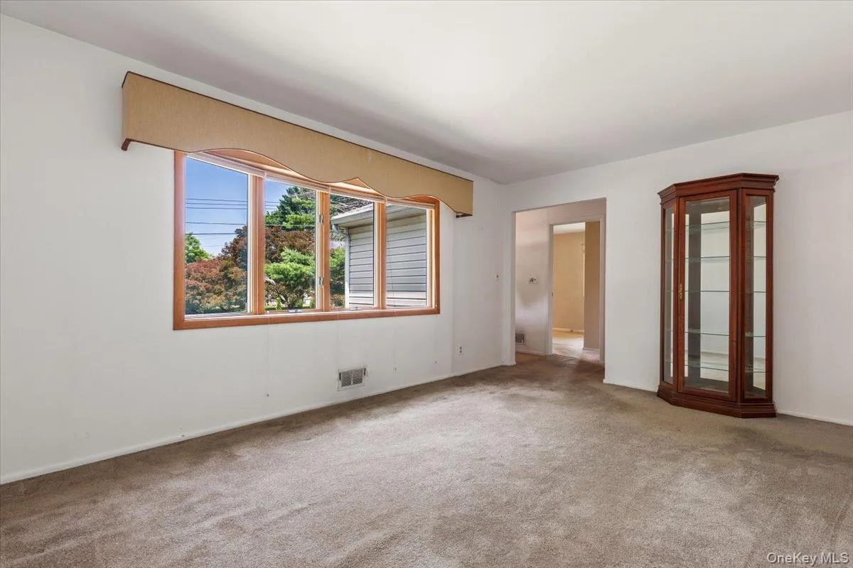 view of entryway from living room with bright bow window view of entryway from living room with bright bow window