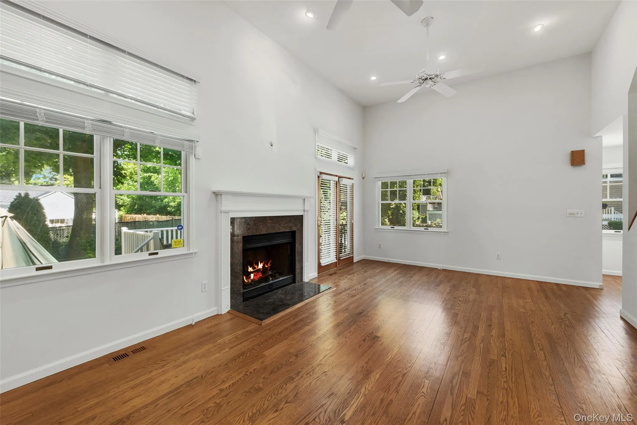 Large living room with sliding glass door to private deck and gas fireplace. Large living room with sliding glass door to private deck and gas fireplace.