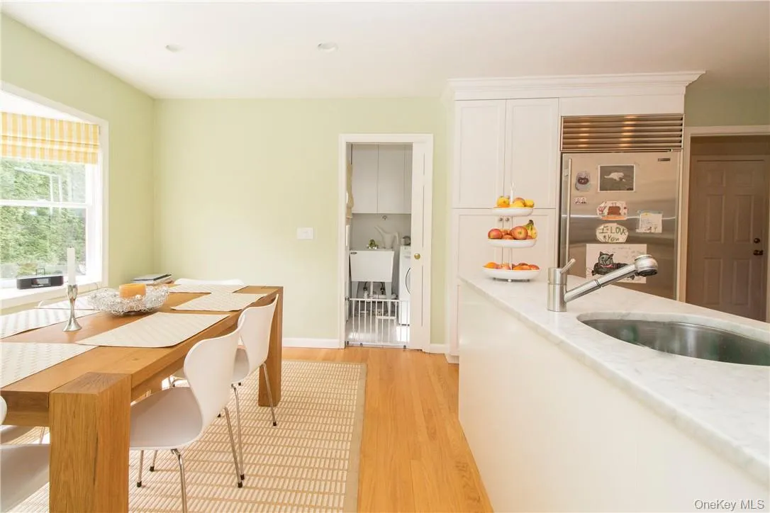 Eat in area of kitchen with bay window and looking towards laundry area and door to patio and backyard Eat in area of kitchen with bay window and looking towards laundry area and door to patio and backyard