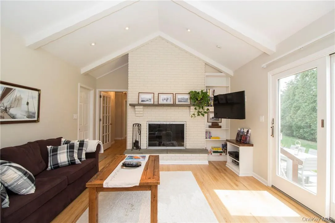 Family room with vaulted ceiling and sliding doors to backyard Family room with vaulted ceiling and sliding doors to backyard