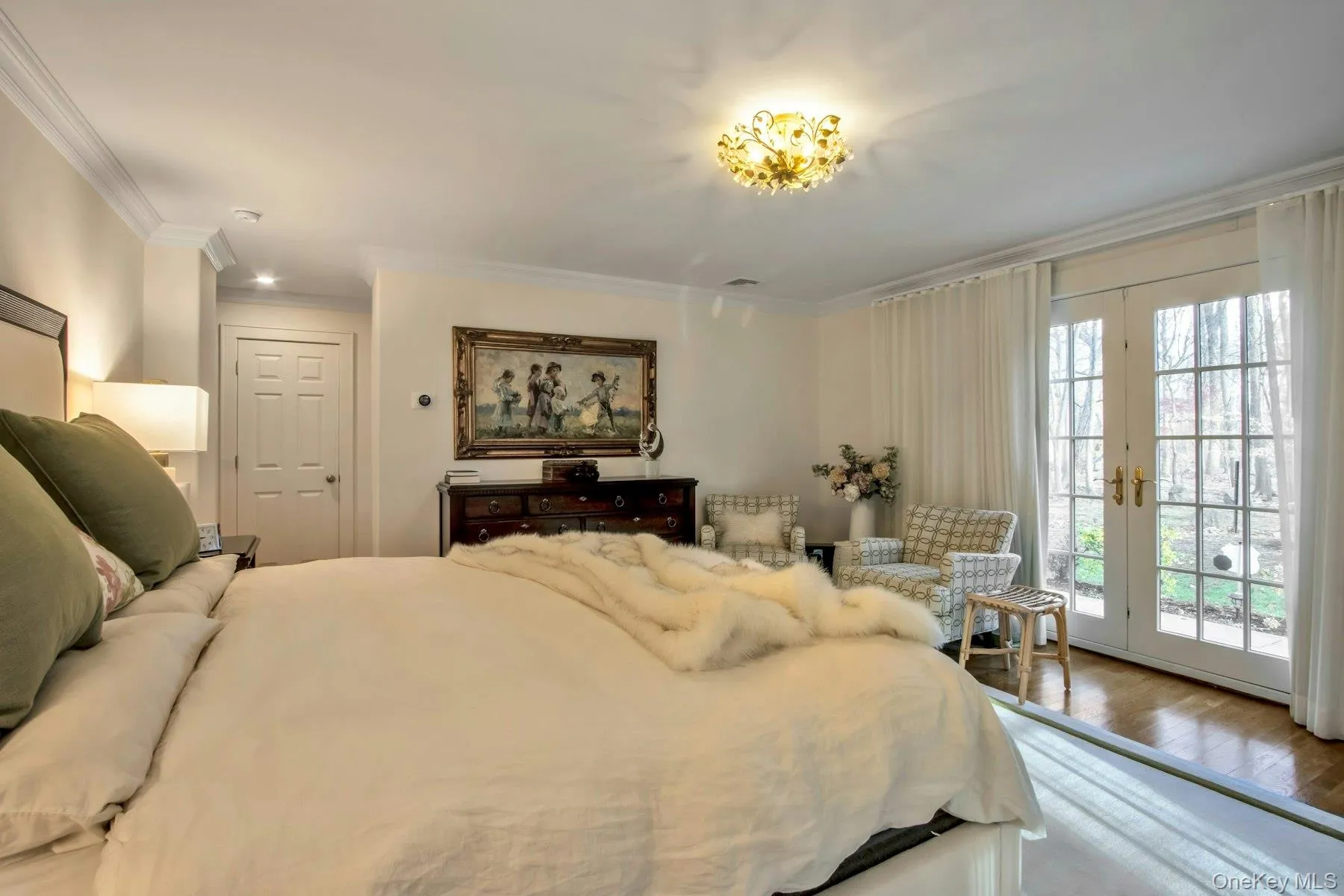 Bedroom featuring access to exterior, wood-type flooring, french doors, and ornamental molding Bedroom featuring access to exterior, wood-type flooring, french doors, and ornamental molding