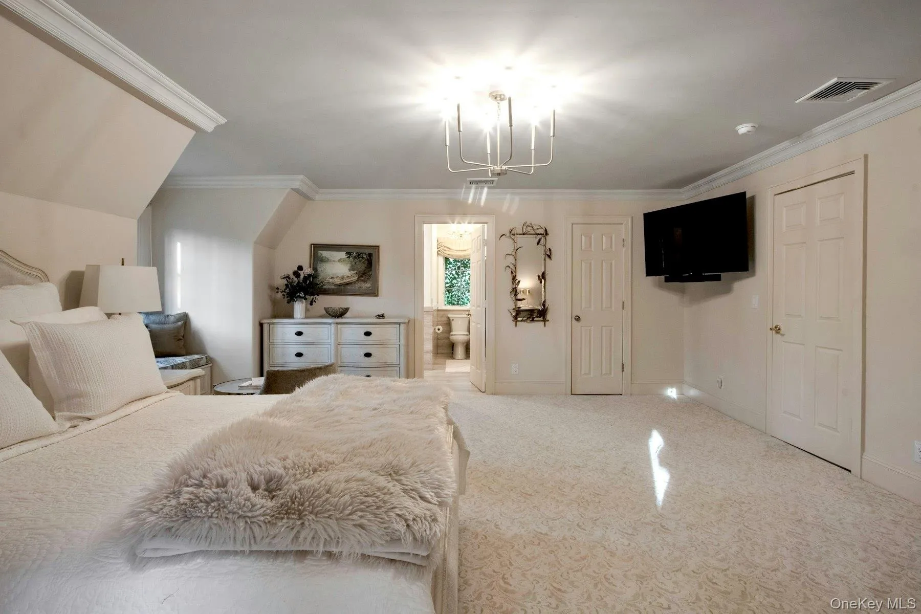 Carpeted bedroom featuring ensuite bath and crown molding Carpeted bedroom featuring ensuite bath and crown molding