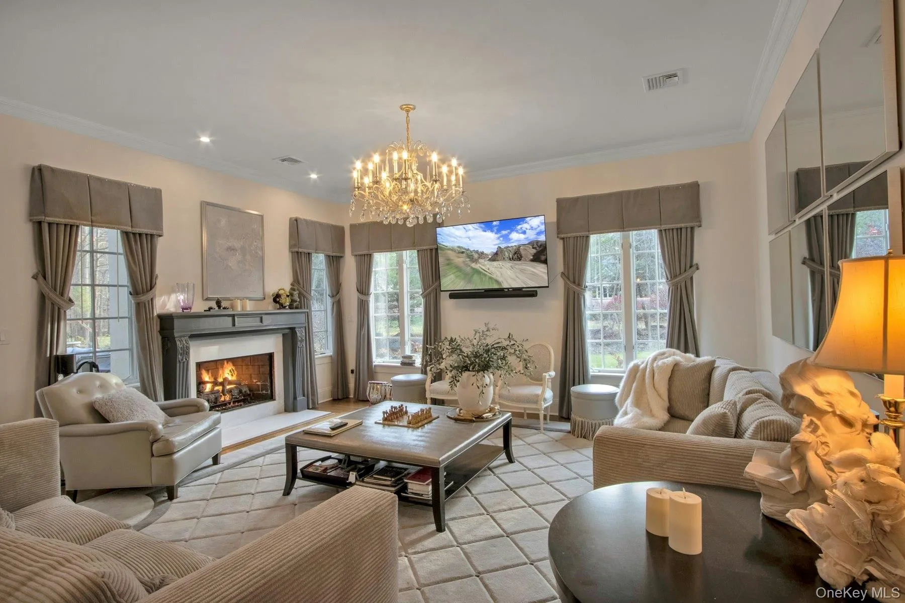 Family room with crown molding and an inviting chandelier Family room with crown molding and an inviting chandelier