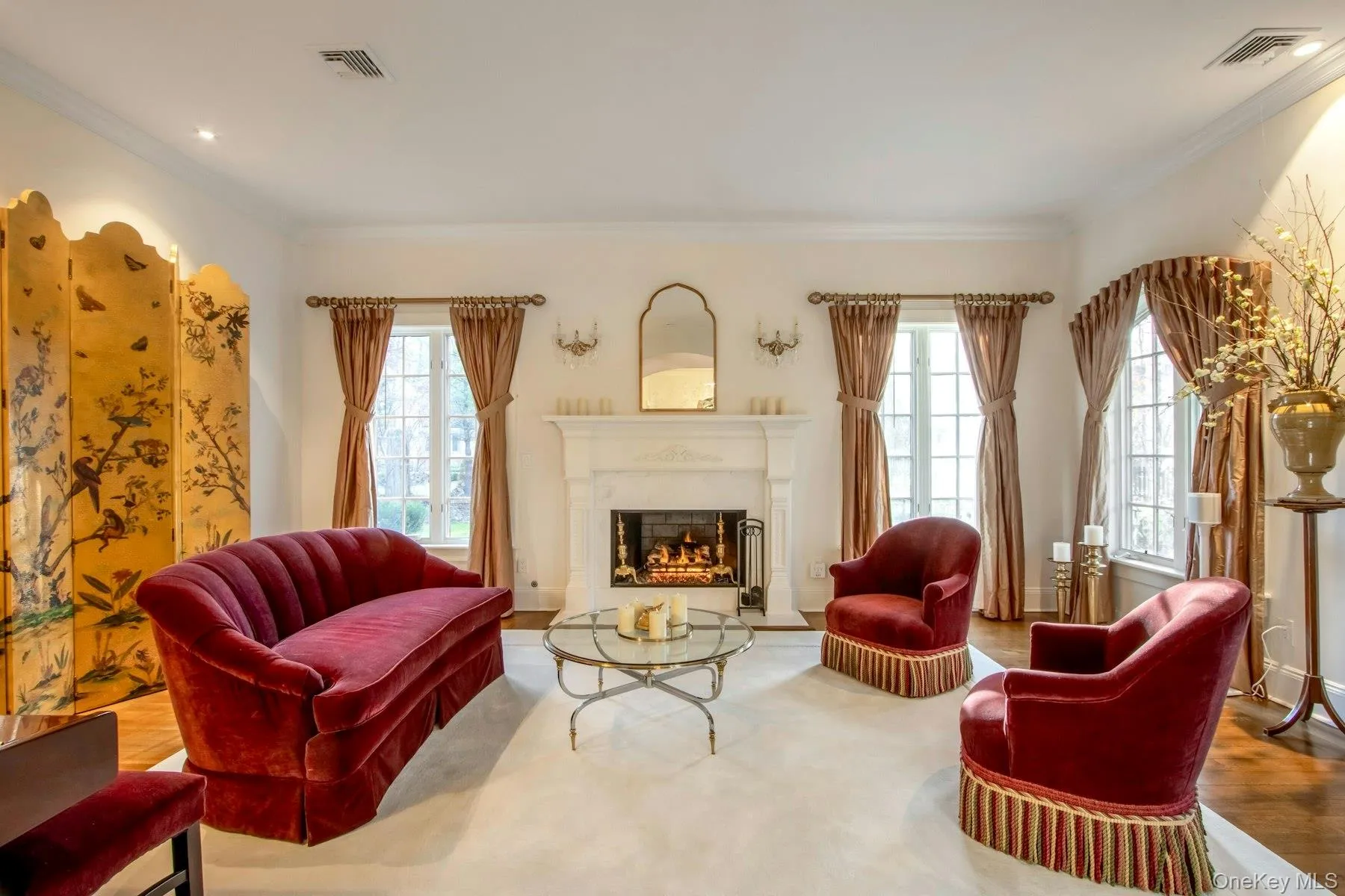 Living area featuring hardwood / wood-style flooring and crown molding Living area featuring hardwood / wood-style flooring and crown molding