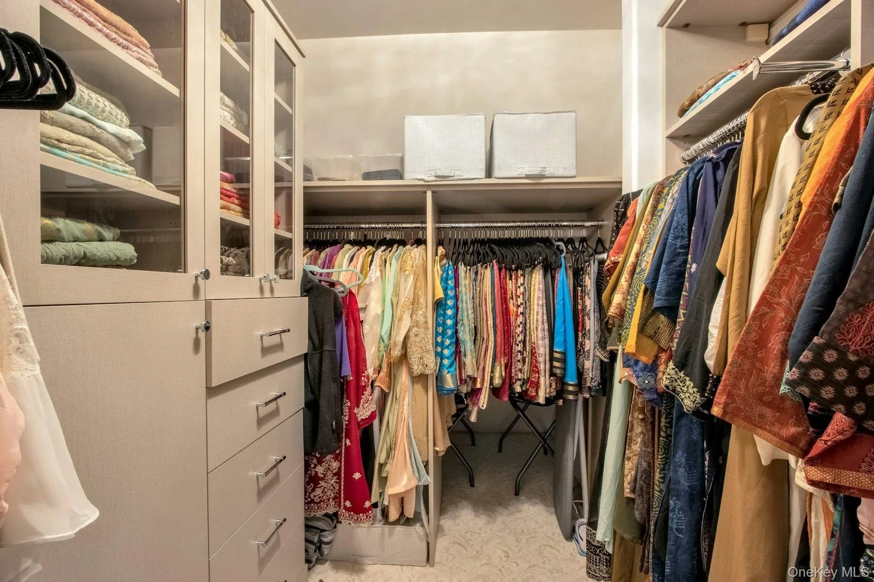 Spacious closet with carpet flooring Spacious closet with carpet flooring