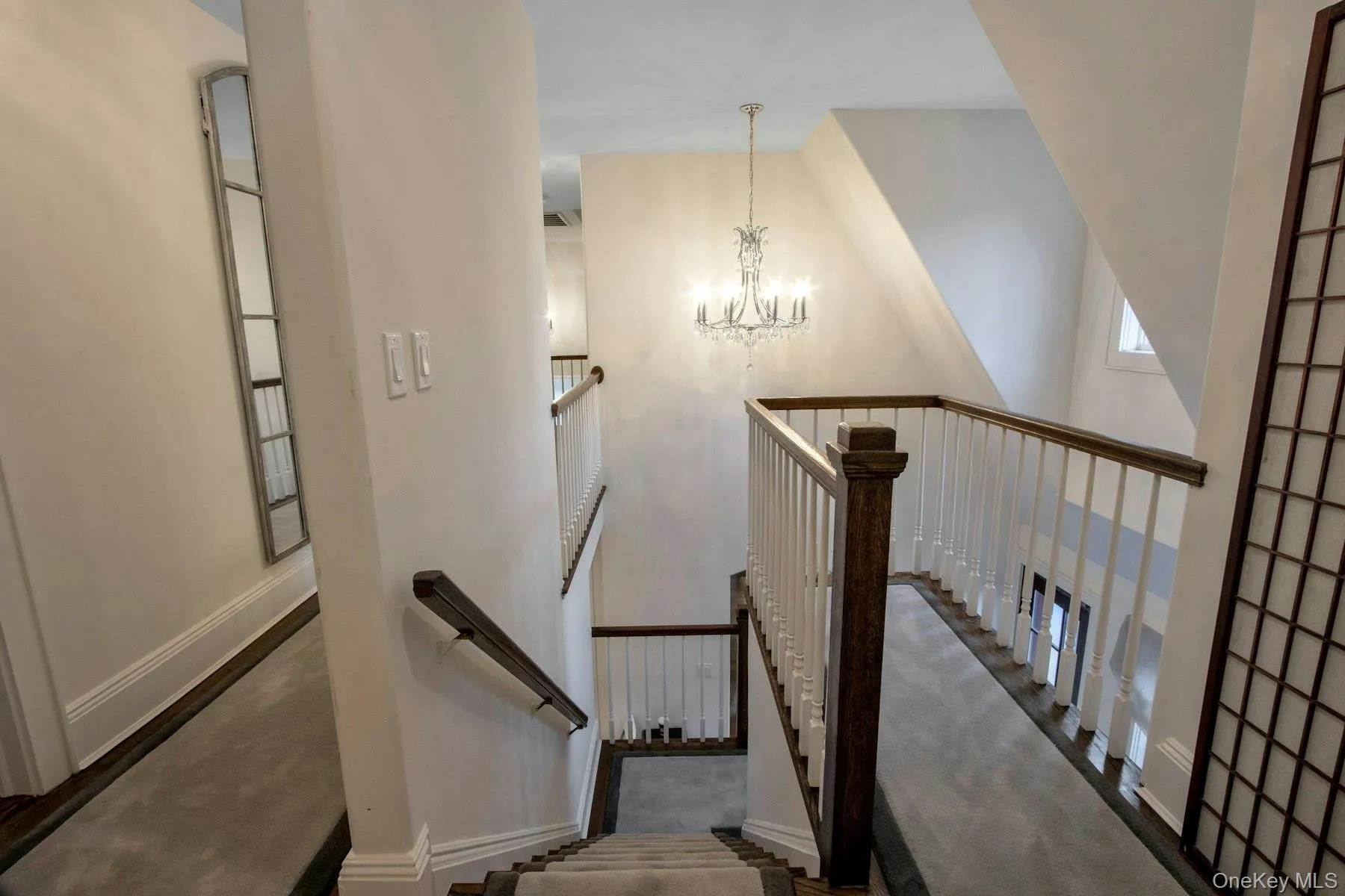 Stairway featuring a chandelier and a high ceiling Stairway featuring a chandelier and a high ceiling
