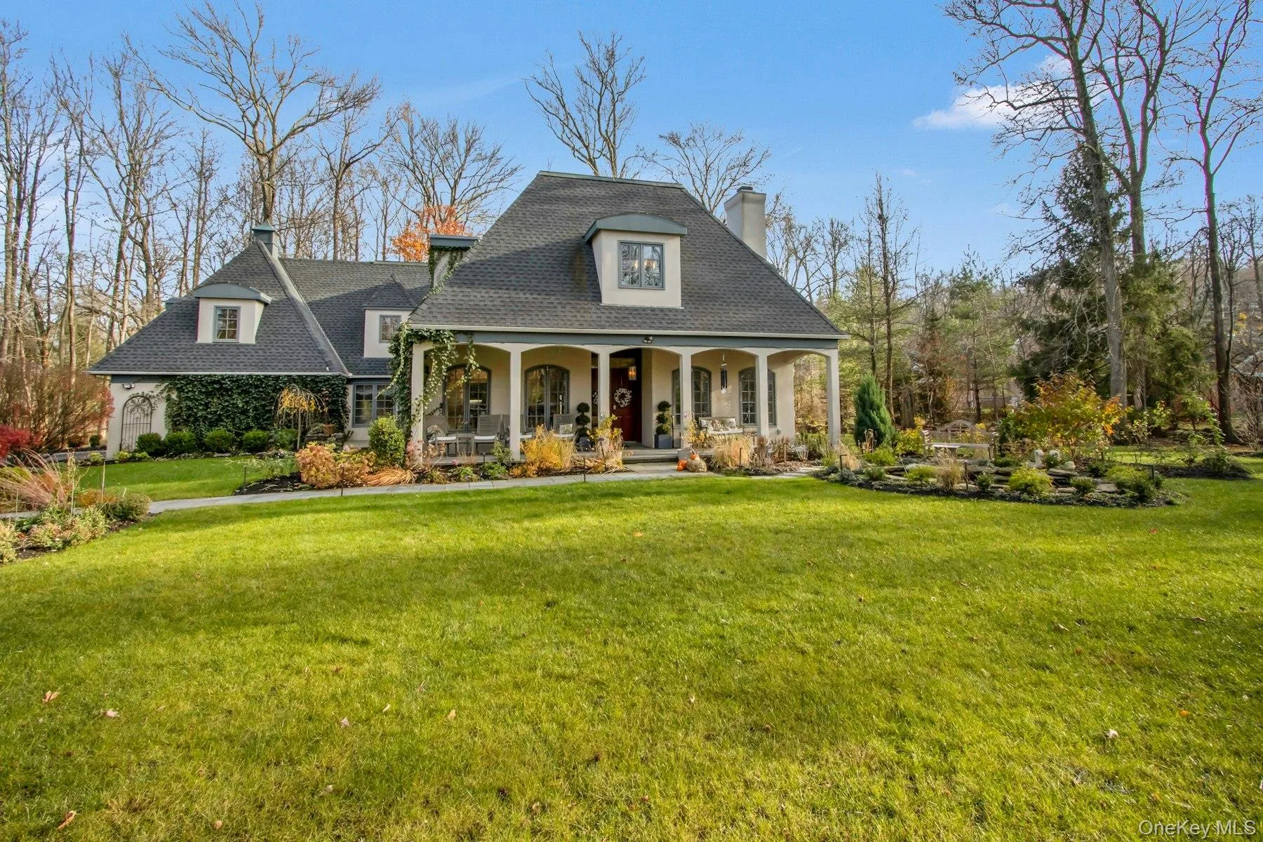 View of front facade featuring a front lawn and covered porch View of front facade featuring a front lawn and covered porch