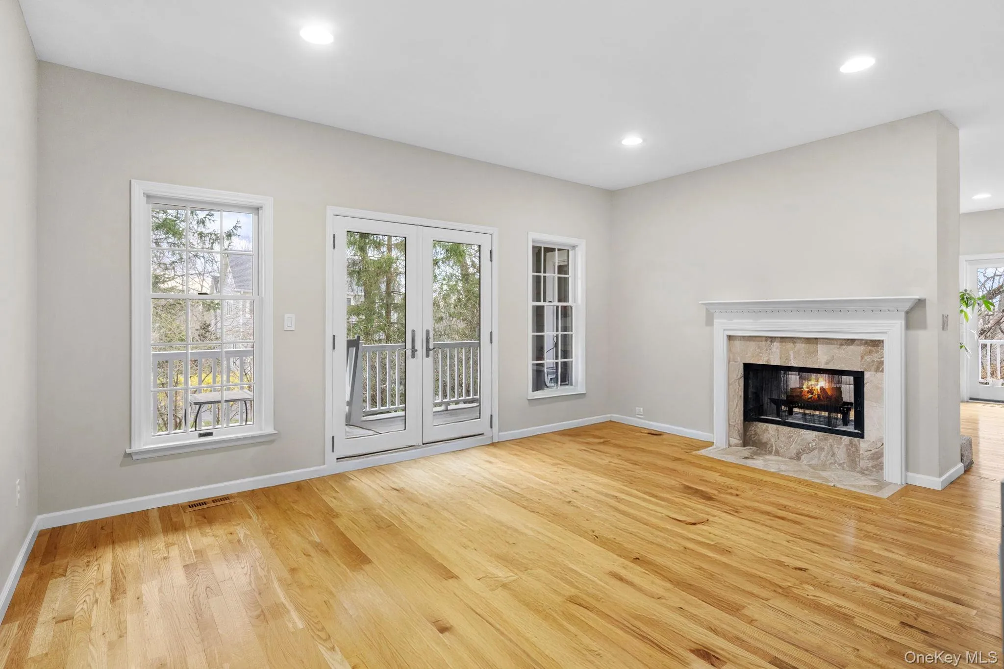 living room with fireplace and french doors to wrap around porch living room with fireplace and french doors to wrap around porch
