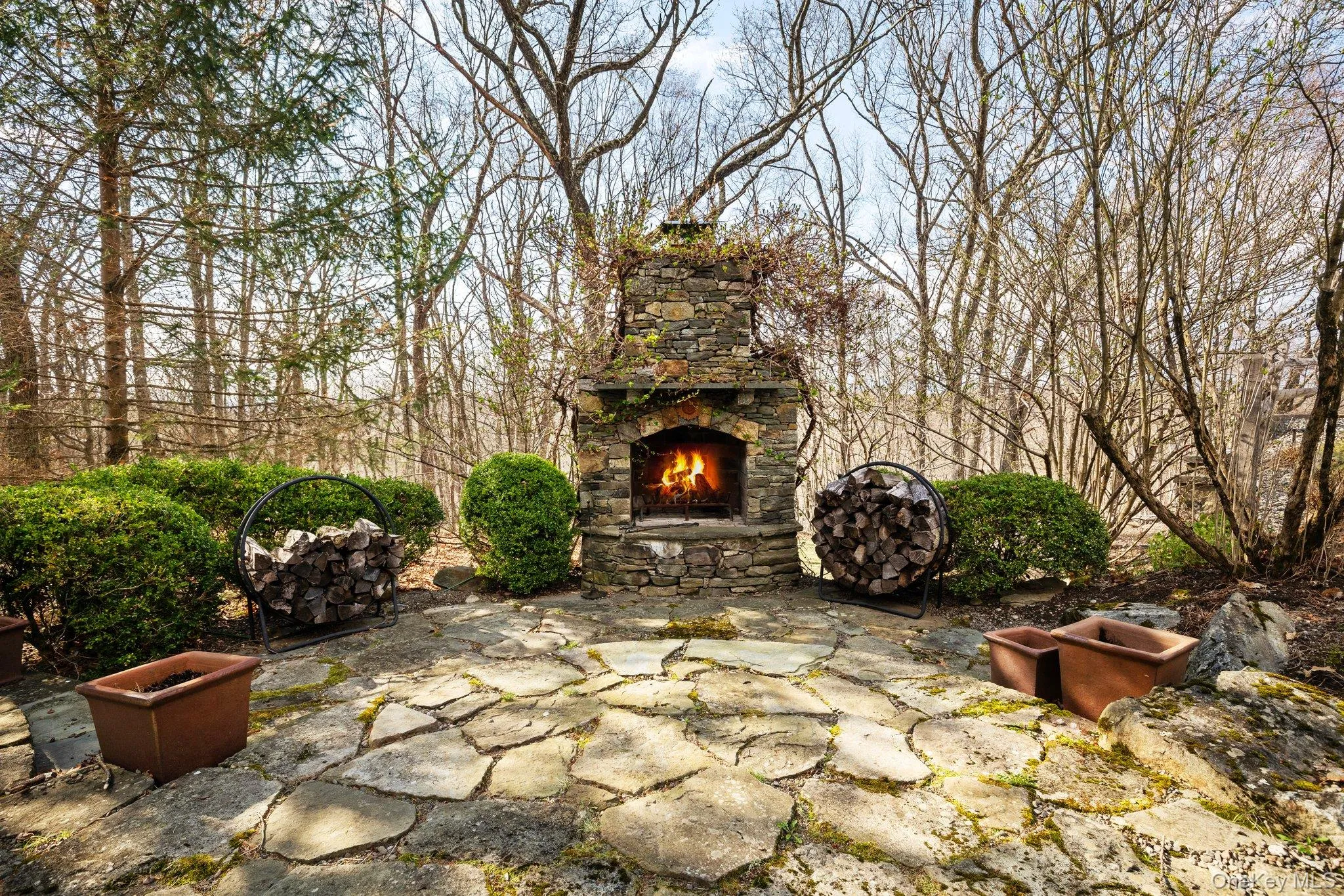 View of patio with an outdoor stone fireplace View of patio with an outdoor stone fireplace