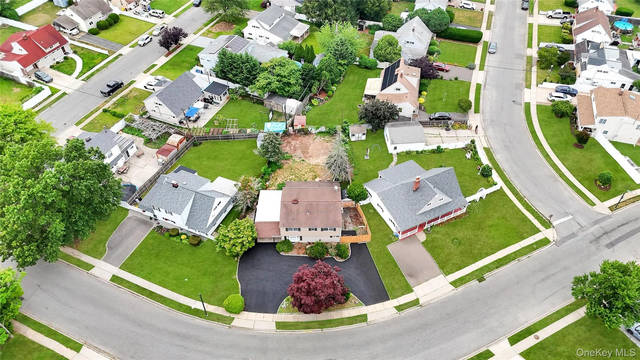 Residential neighborhood featuring mature trees and curvilinear street design Residential neighborhood featuring mature trees and curvilinear street design
