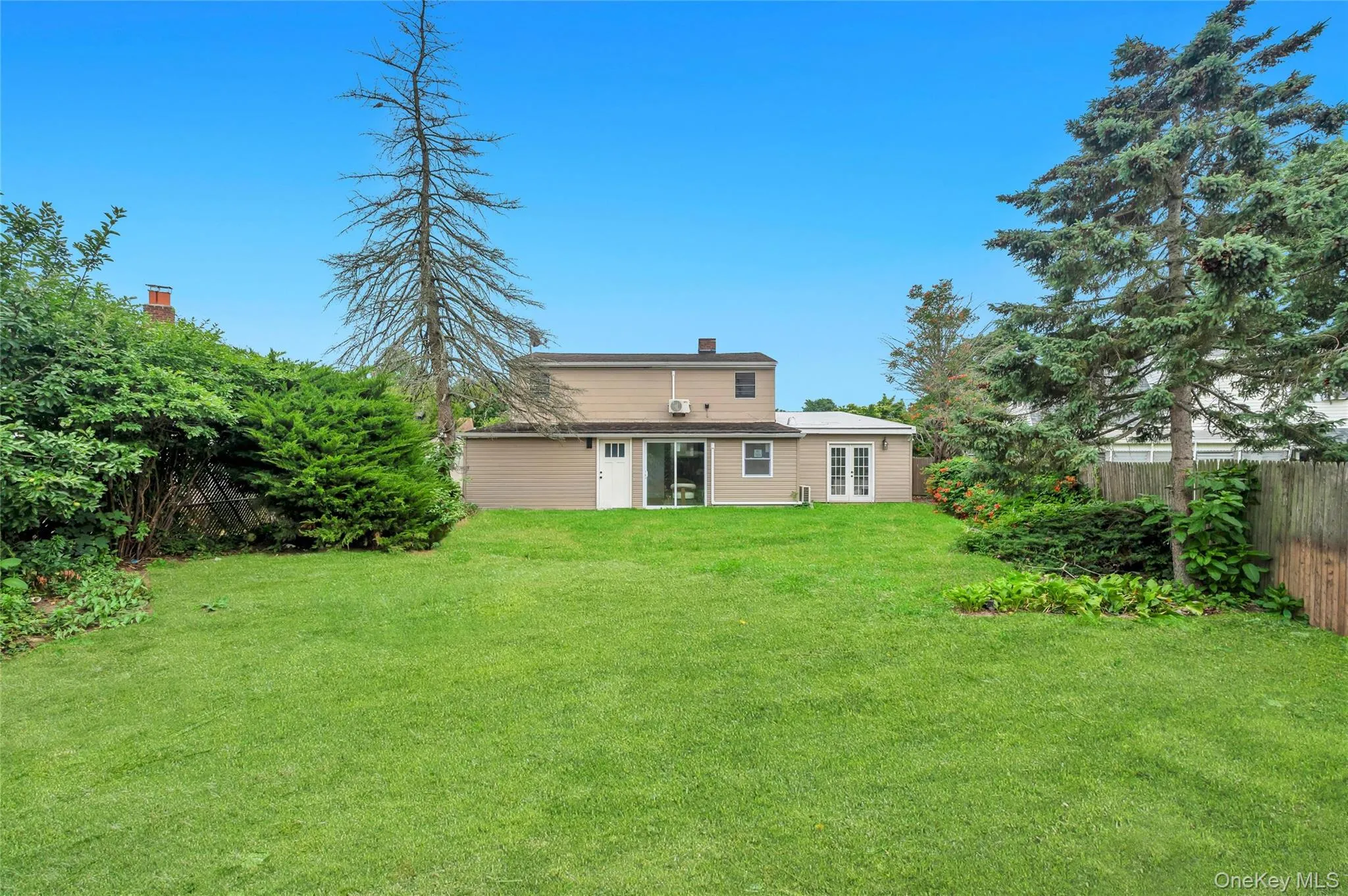Expansive green lawn with mature perimeter landscaping Expansive green lawn with mature perimeter landscaping