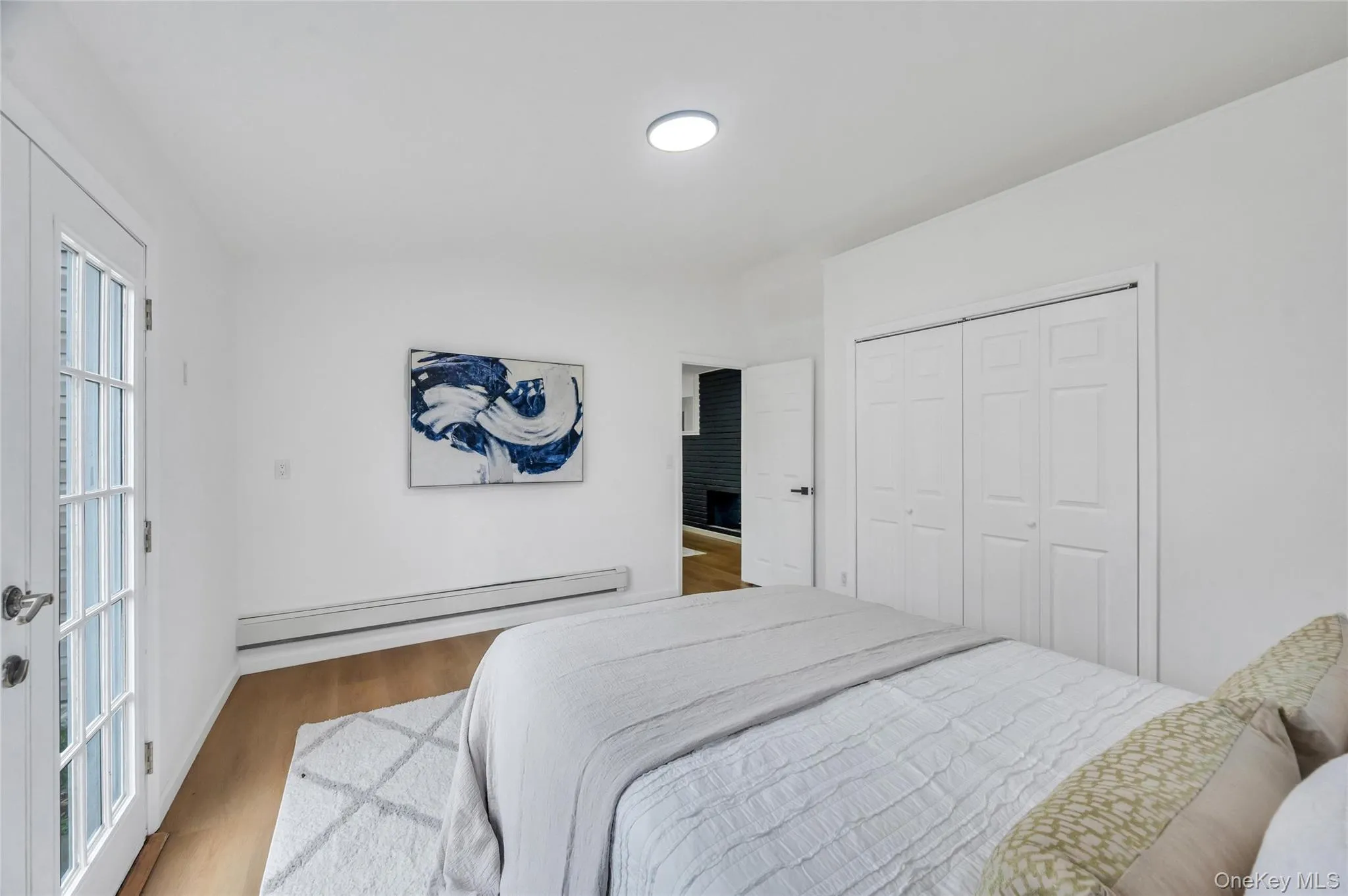 Hardwood-finish flooring featuring a white ceiling and walls Hardwood-finish flooring featuring a white ceiling and walls