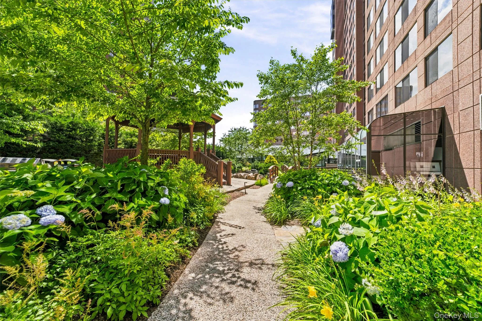 Step outside and unwind in the beautifully maintained garden area, featuring scenic pathways and tranquil green space Step outside and unwind in the beautifully maintained garden area, featuring scenic pathways and tranquil green space