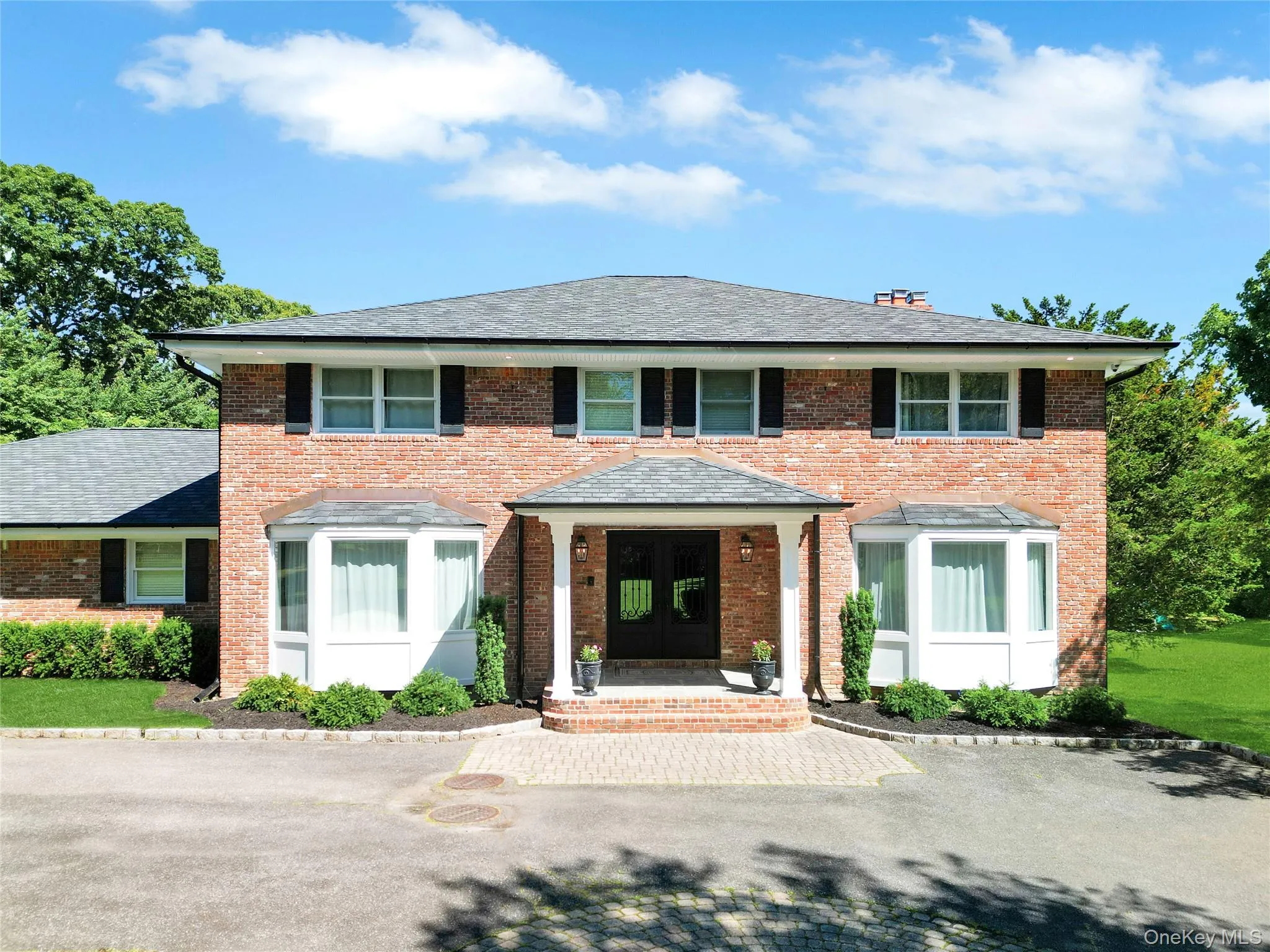 View of front of property with french doors and brick siding. View of front of property with french doors and brick siding.