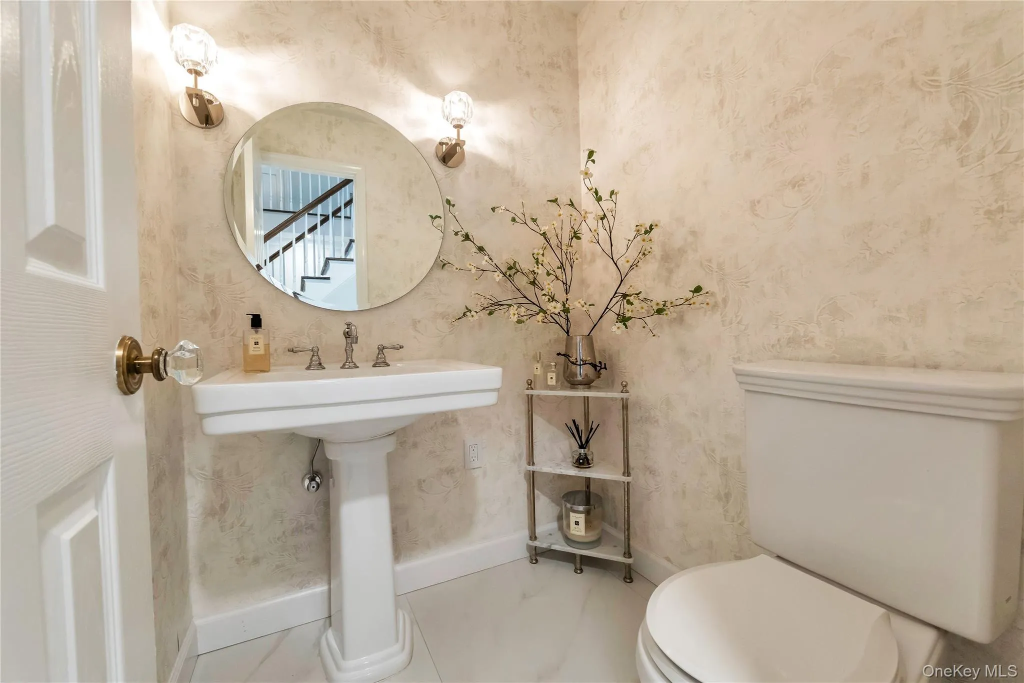 Bathroom featuring toilet and wallpapered walls Bathroom featuring toilet and wallpapered walls