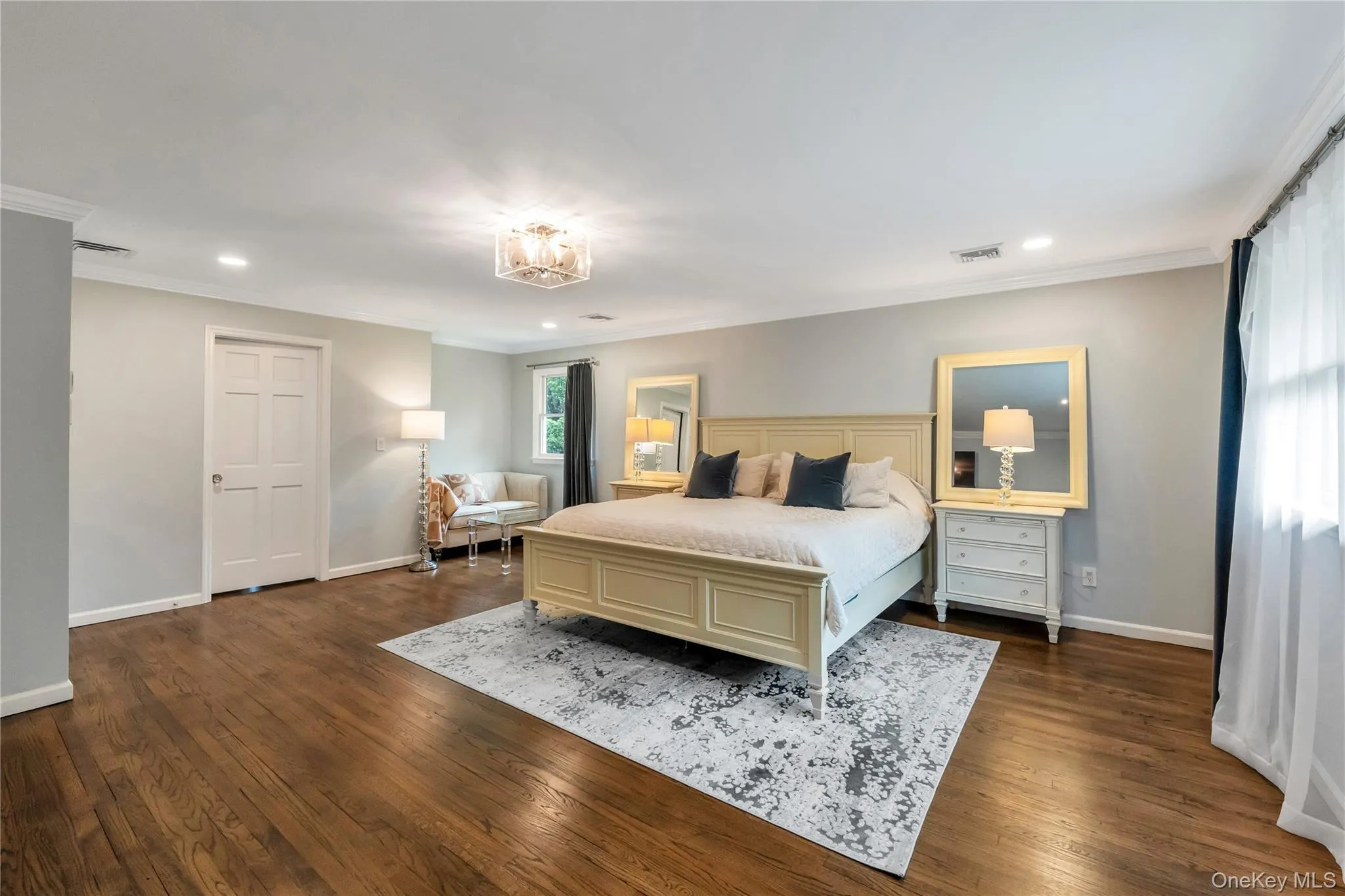Bedroom with ornamental molding, baseboards, recessed lighting, dark wood finished floors, and a chandelier Bedroom with ornamental molding, baseboards, recessed lighting, dark wood finished floors, and a chandelier