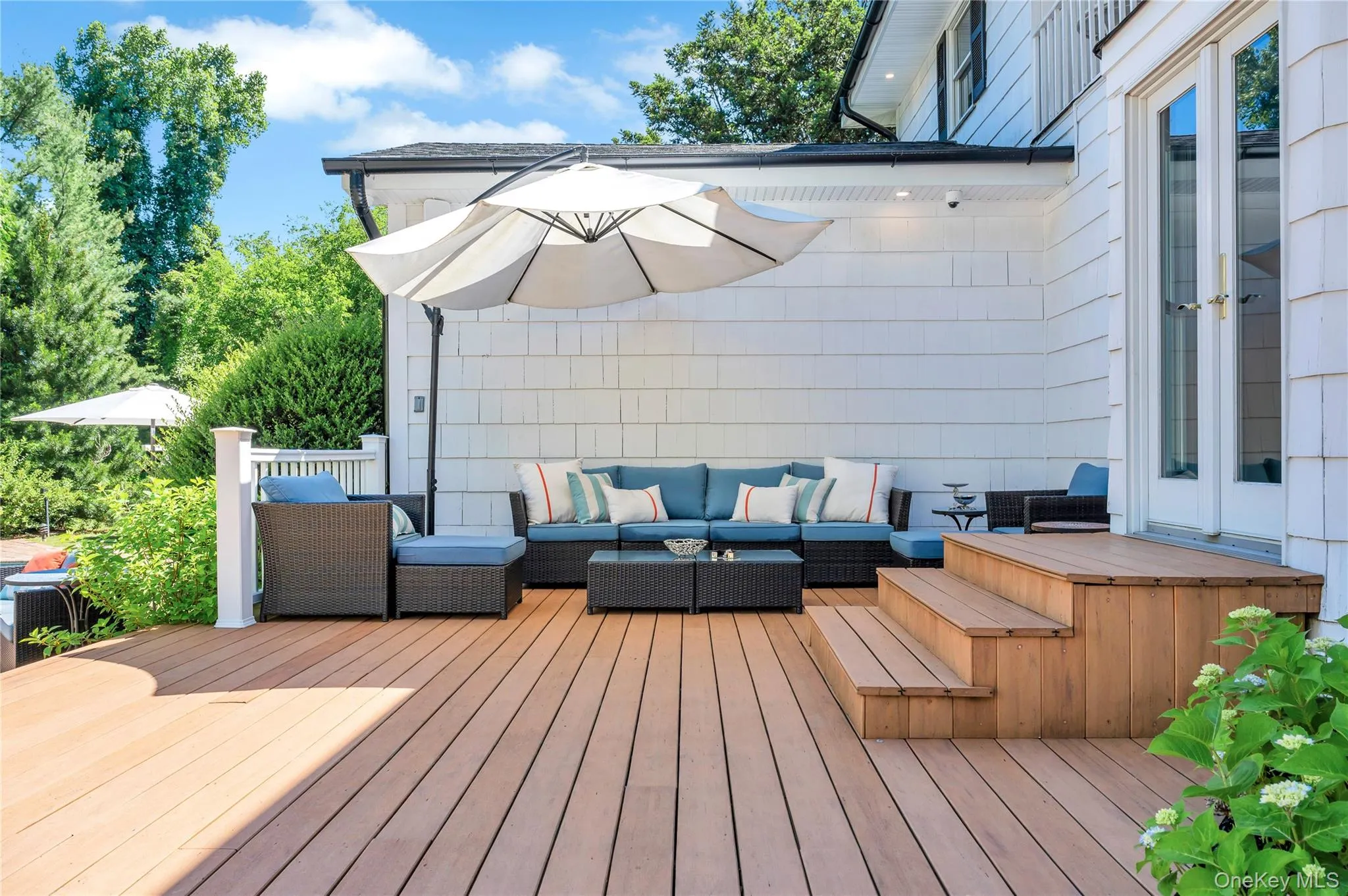 Wooden terrace with an outdoor hangout area and french doors Wooden terrace with an outdoor hangout area and french doors