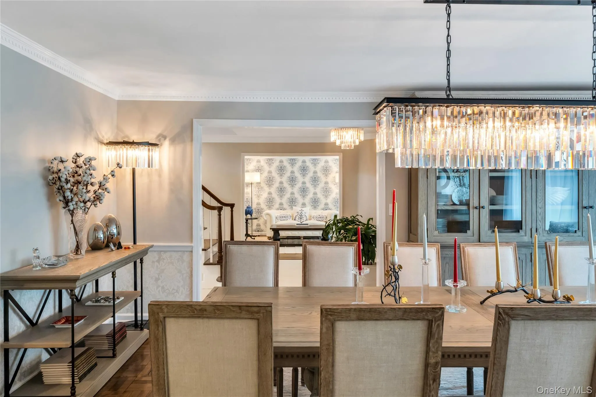 Dining room featuring a chandelier, ornamental molding, and stairway Dining room featuring a chandelier, ornamental molding, and stairway
