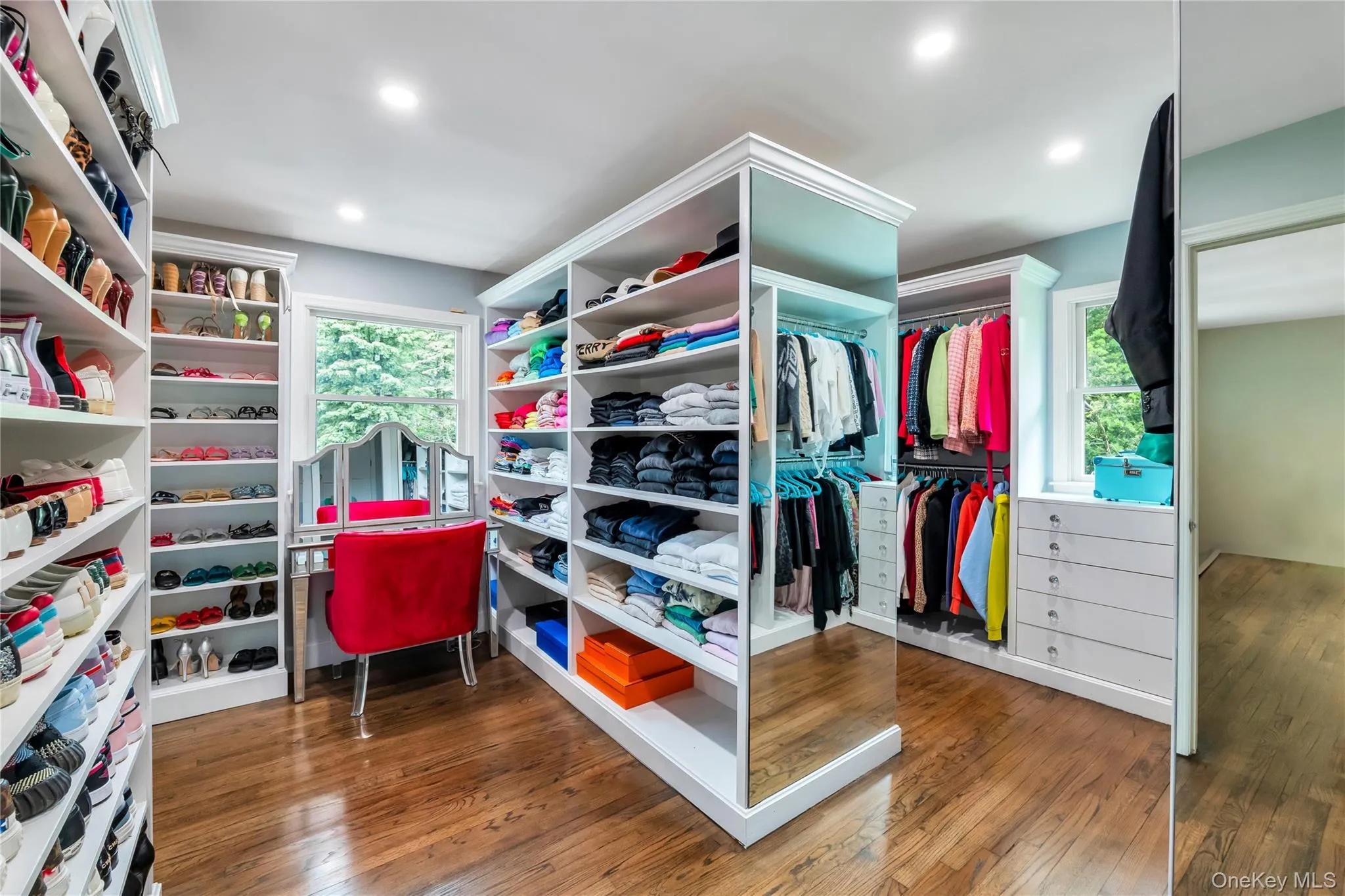 Spacious closet with hardwood / wood-style floors Spacious closet with hardwood / wood-style floors