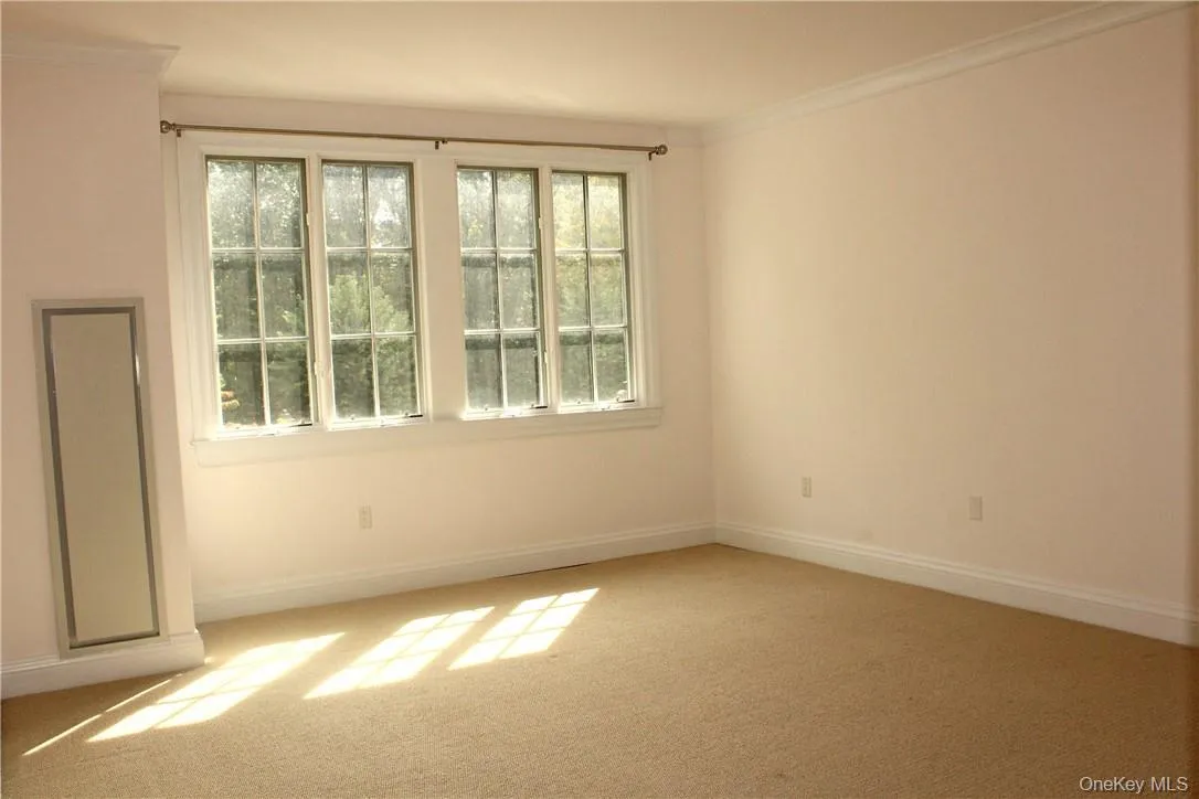 The primary bedroom streams in sunshine. The primary bedroom streams in sunshine.