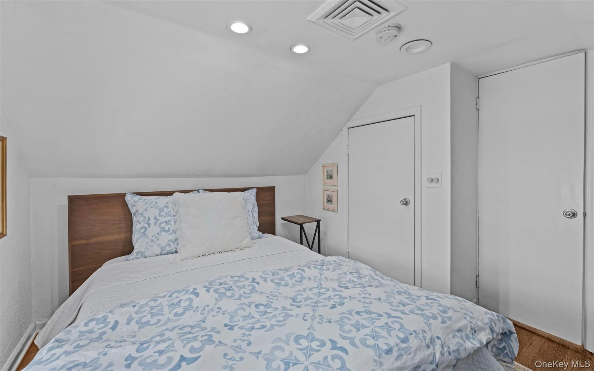Second floor bedroom featuring recessed lighting, and hardwood flooring Second floor bedroom featuring recessed lighting, and hardwood flooring
