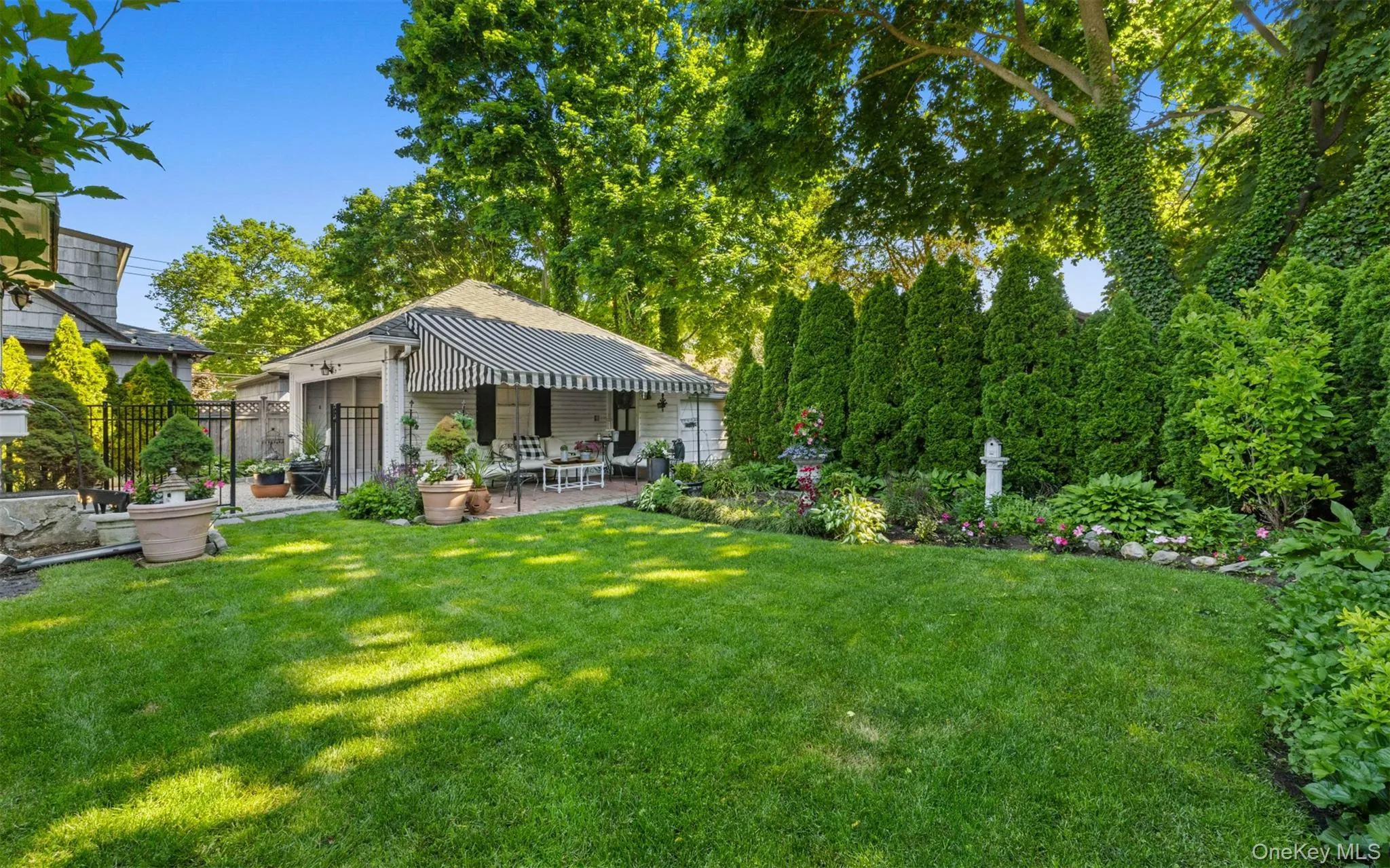 Gorgeous gardens and brick patio with awning, gated and fenced backyard,total privacy, IGS Gorgeous gardens and brick patio with awning, gated and fenced backyard,total privacy, IGS