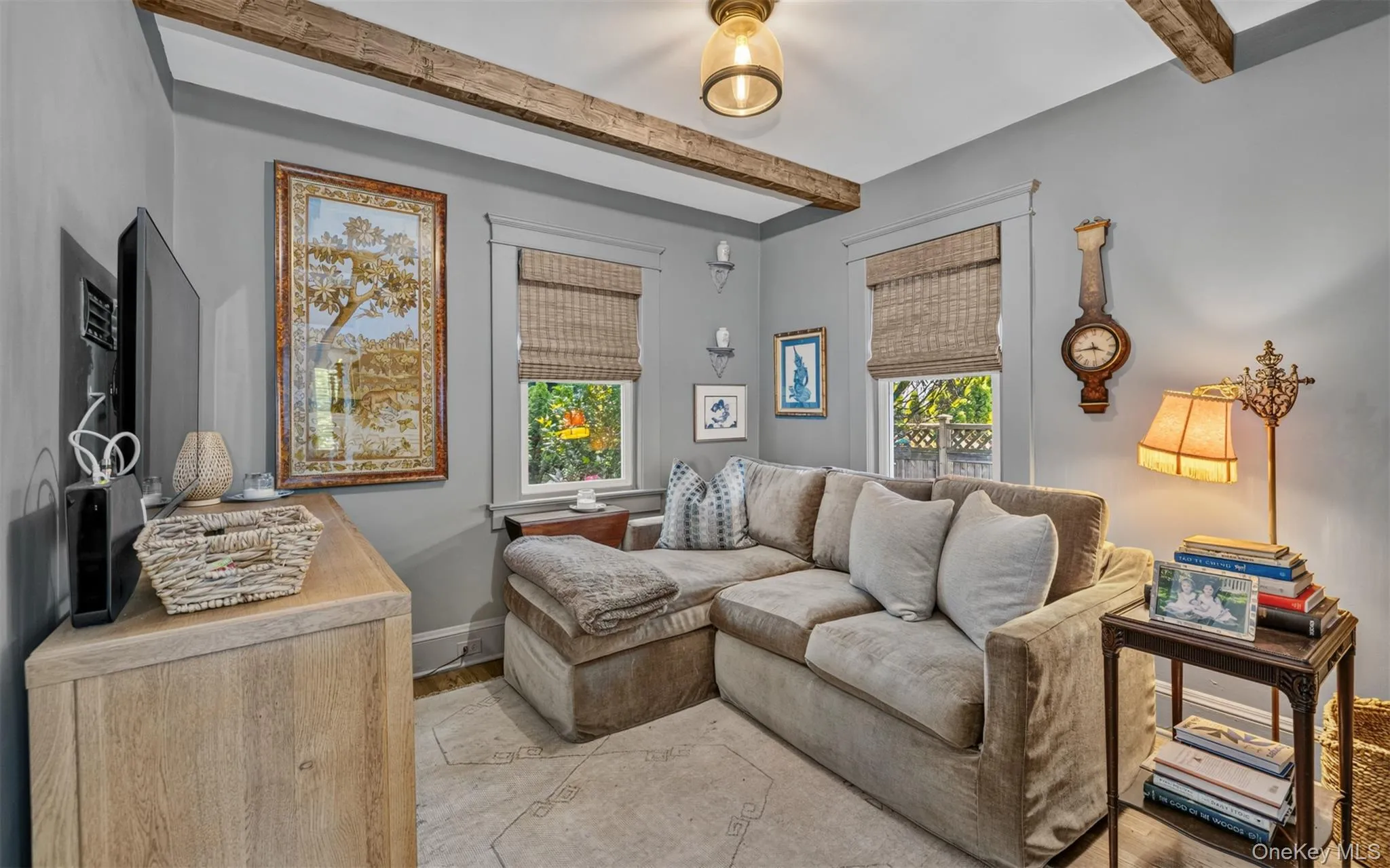 Exposed wood ceiling beams accent the room, complemented by neutral wall tones Exposed wood ceiling beams accent the room, complemented by neutral wall tones