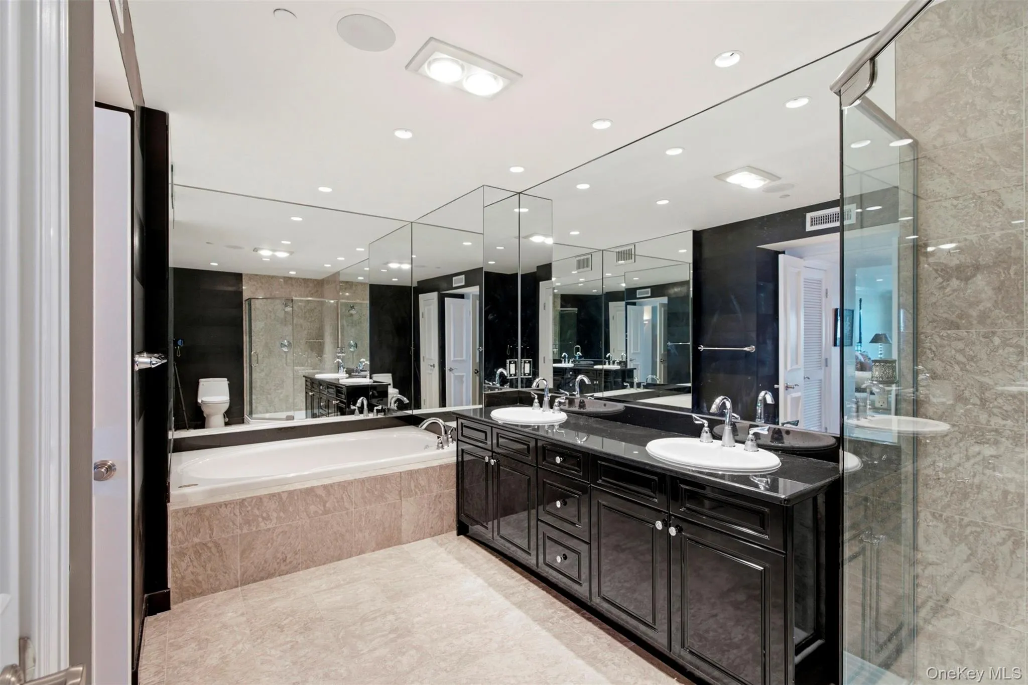 Luxury marble bath with granite counters, double vanity, jetted tub and separate shower. Luxury marble bath with granite counters, double vanity, jetted tub and separate shower.