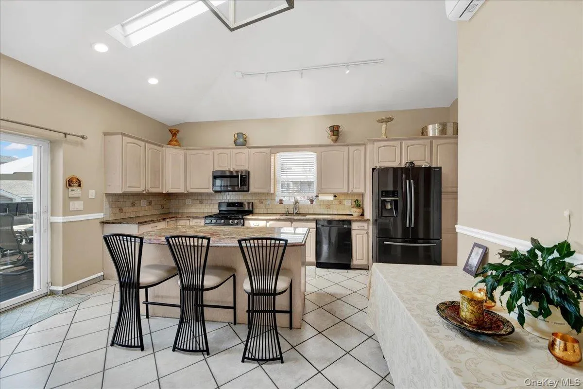Spacious sunlit kitchen with center and slider to open 14 x 15 deck Spacious sunlit kitchen with center and slider to open 14 x 15 deck