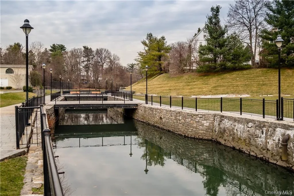Dock area with a water view and view of scattered trees Dock area with a water view and view of scattered trees