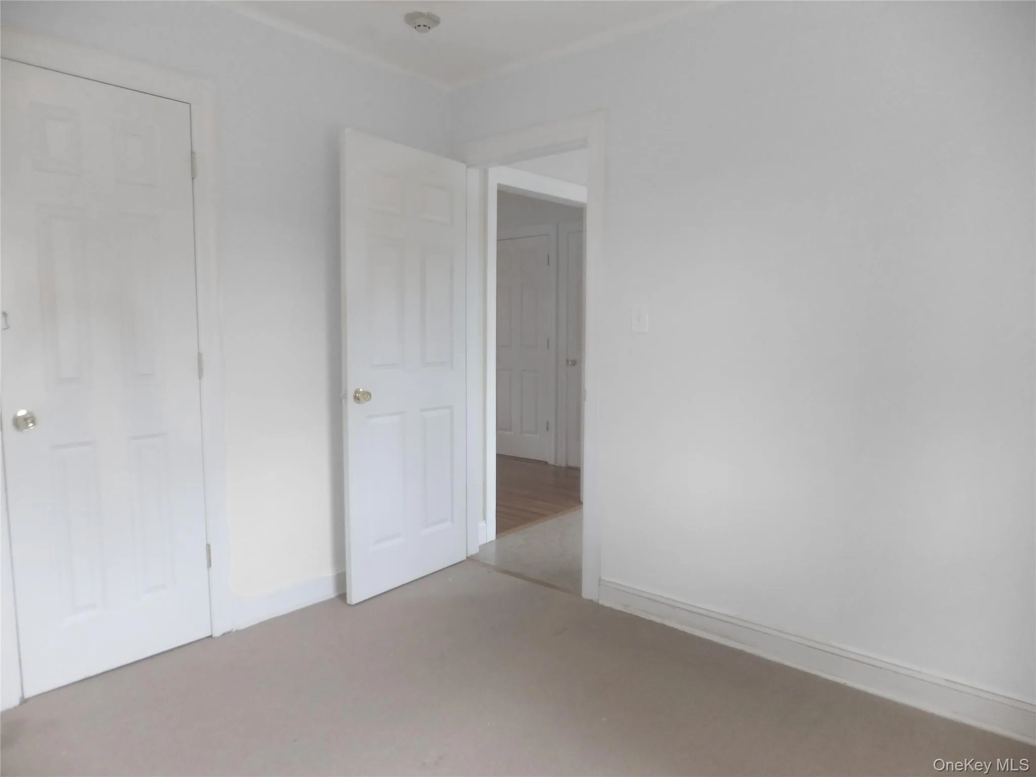 Unfurnished bedroom featuring carpet and baseboards Unfurnished bedroom featuring carpet and baseboards