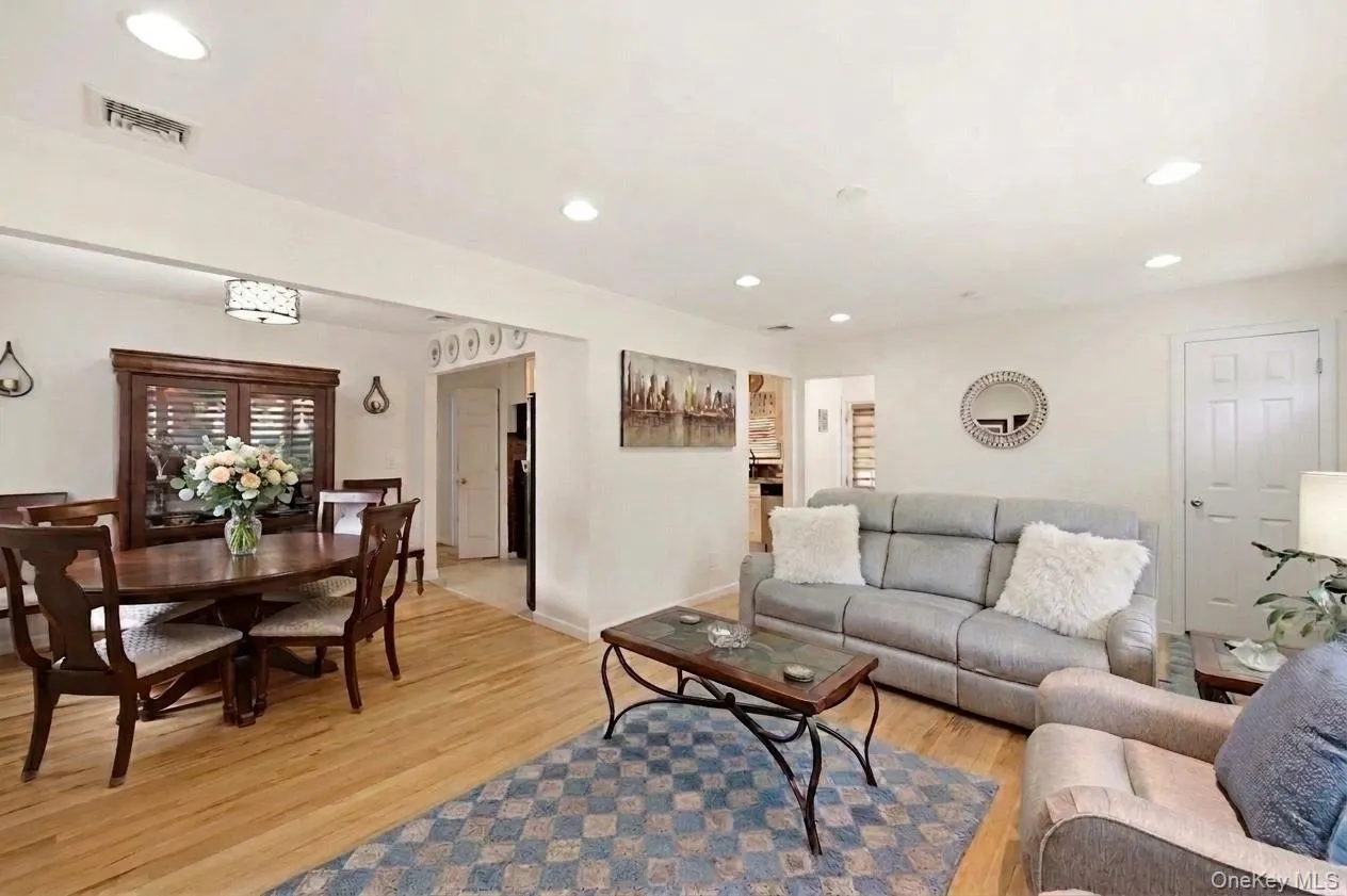 Open-concept living and dining areas featuring beautiful gleaming hard wood floors, recessed lighting, and a versatile floor-plan. Open-concept living and dining areas featuring beautiful gleaming hard wood floors, recessed lighting, and a versatile floor-plan.