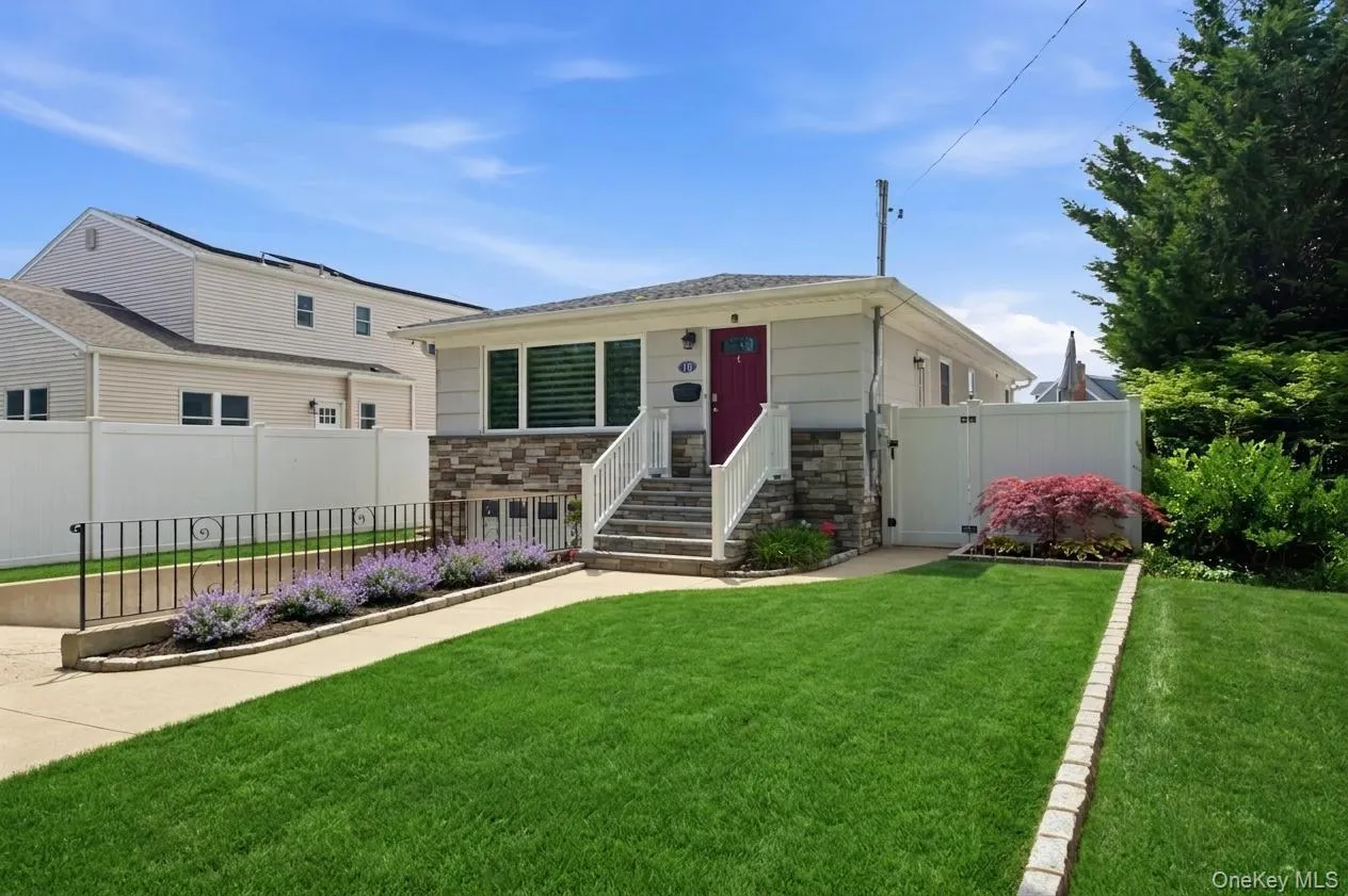 Single-story residence with beautiful curb appeal, featuring a stone facade and white siding Single-story residence with beautiful curb appeal, featuring a stone facade and white siding