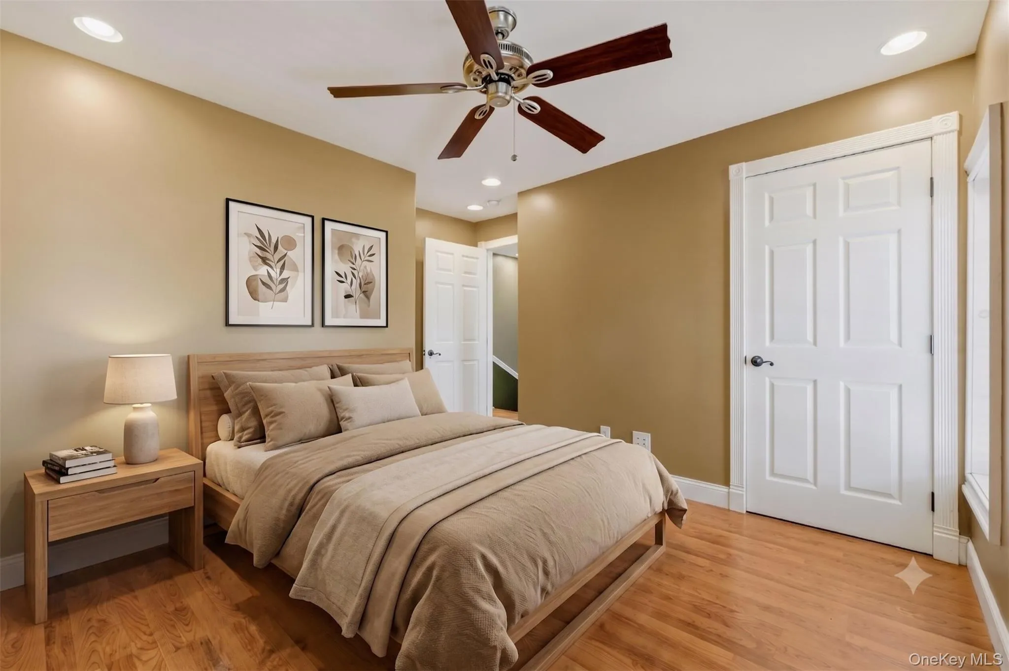 Virtually Staged. Comfortable bedroom with wood-style flooring, ceiling fan, recessed lighting, white trim, and closet access, offering a practical layout for everyday living. Virtually Staged. Comfortable bedroom with wood-style flooring, ceiling fan, recessed lighting, white trim, and closet access, offering a practical layout for everyday living.