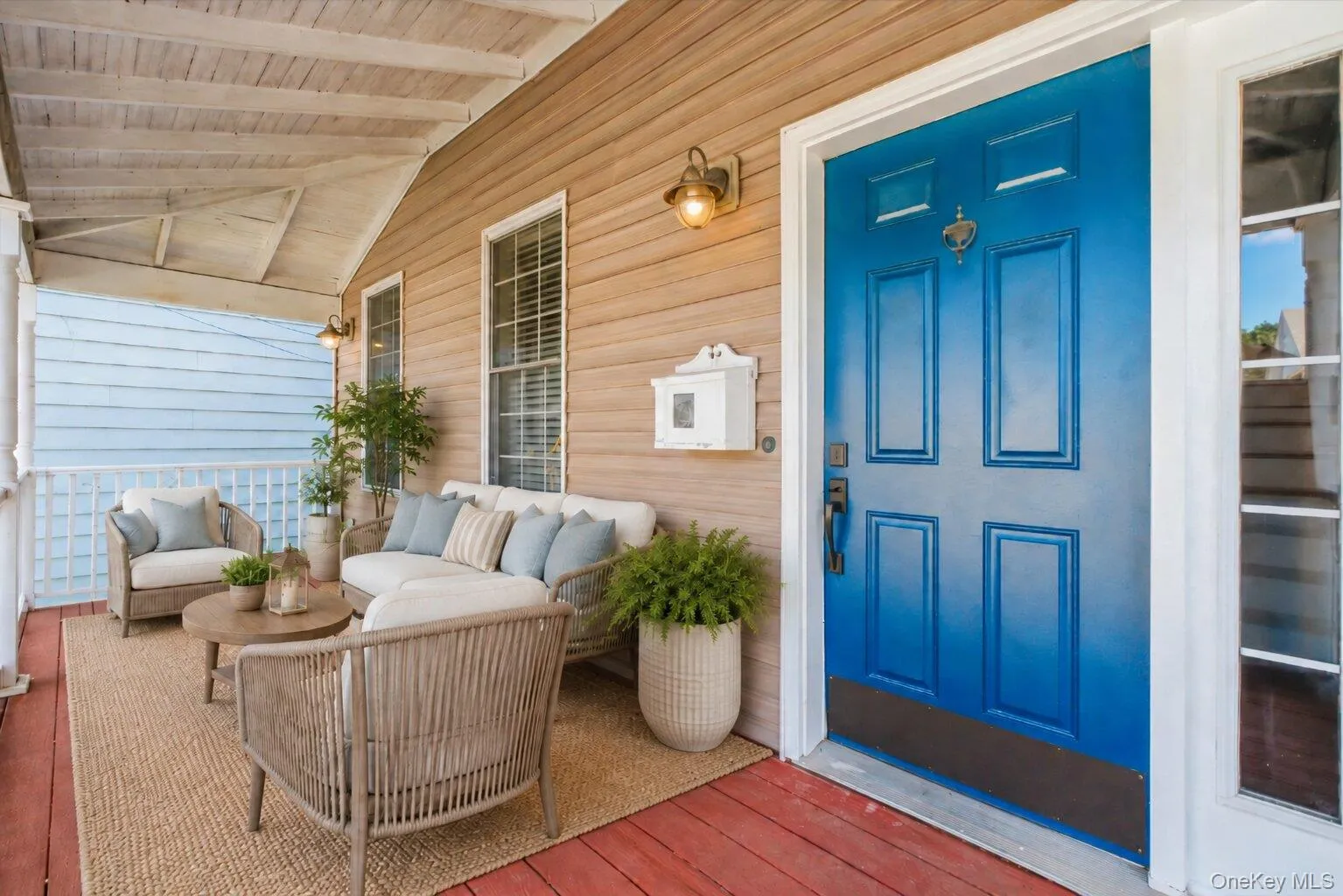 Virtually Staged. Covered front porch with charming wood-tone siding, white railings, and classic porch details, offering a welcoming outdoor space to relax and enjoy the neighborhood setting. Virtually Staged. Covered front porch with charming wood-tone siding, white railings, and classic porch details, offering a welcoming outdoor space to relax and enjoy the neighborhood setting.