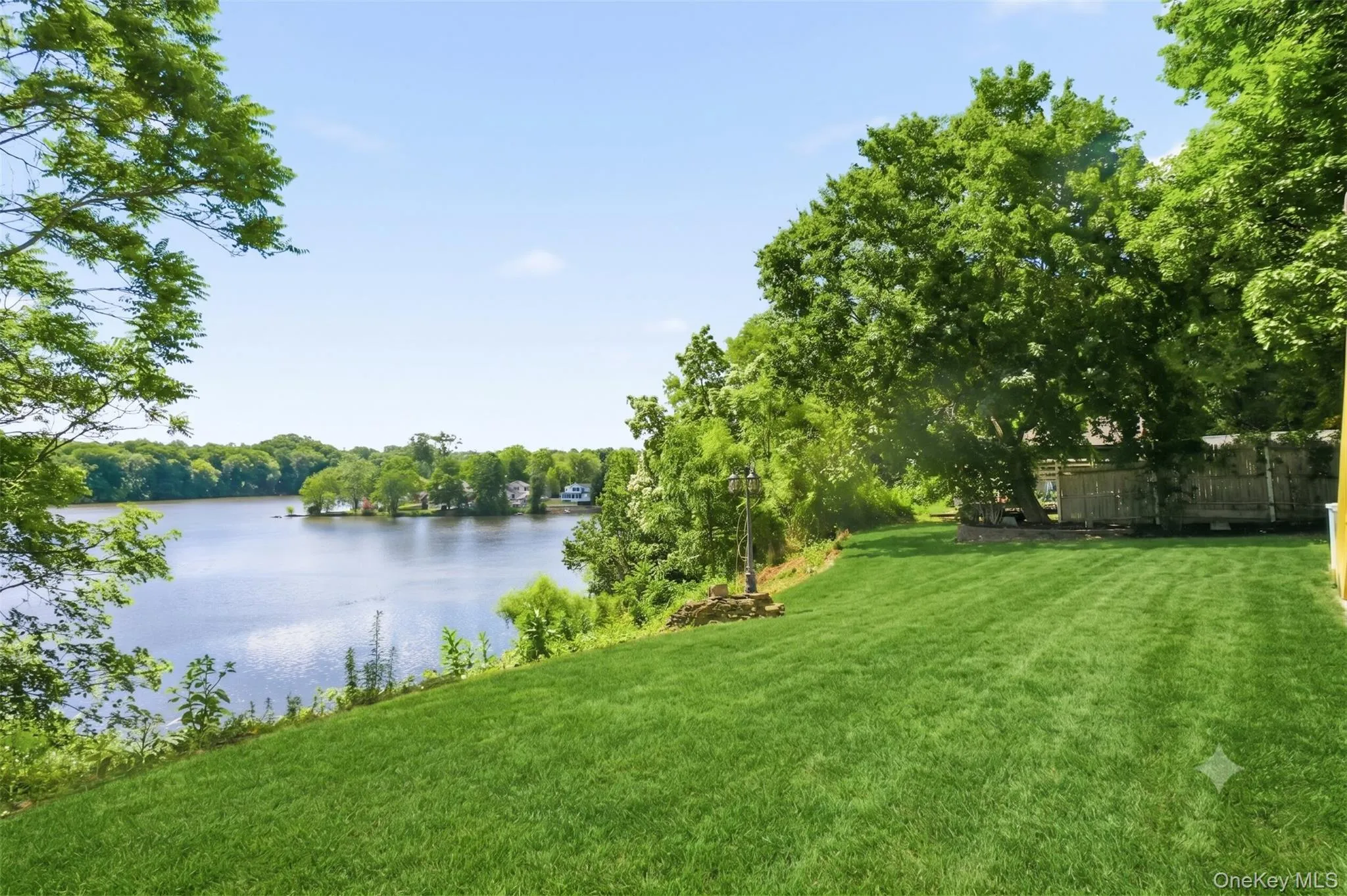 Virtually Staged. Spacious lawn area with mature trees and open water views. Virtually Staged. Spacious lawn area with mature trees and open water views.