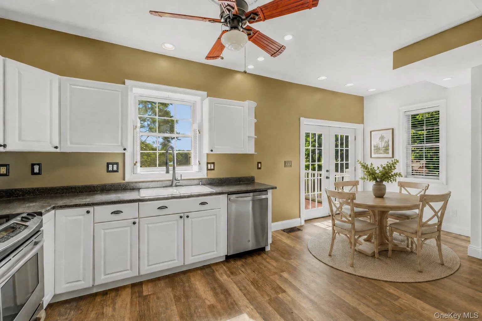 Virtually Staged. Kitchen and dining area showcasing a cozy breakfast nook with a round dining table, neutral décor, and natural accents to help buyers visualize the space for casual meals and entertaining. Virtually Staged. Kitchen and dining area showcasing a cozy breakfast nook with a round dining table, neutral décor, and natural accents to help buyers visualize the space for casual meals and entertaining.
