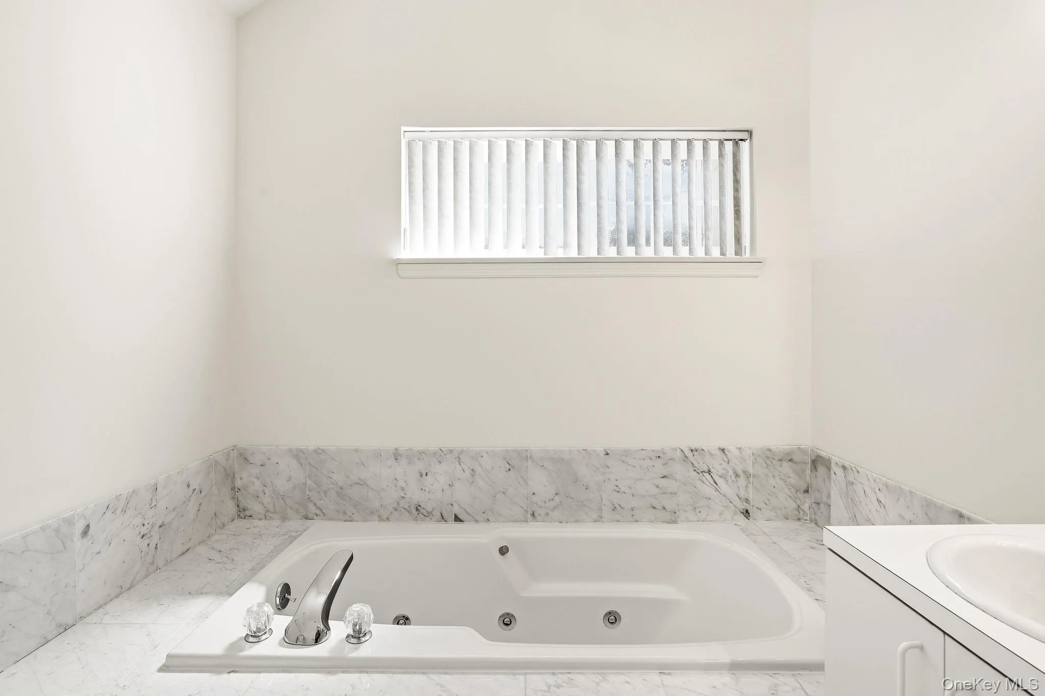 There is a jacuzzi bath tub with a marble surround, for relaxing at the end of the day There is a jacuzzi bath tub with a marble surround, for relaxing at the end of the day