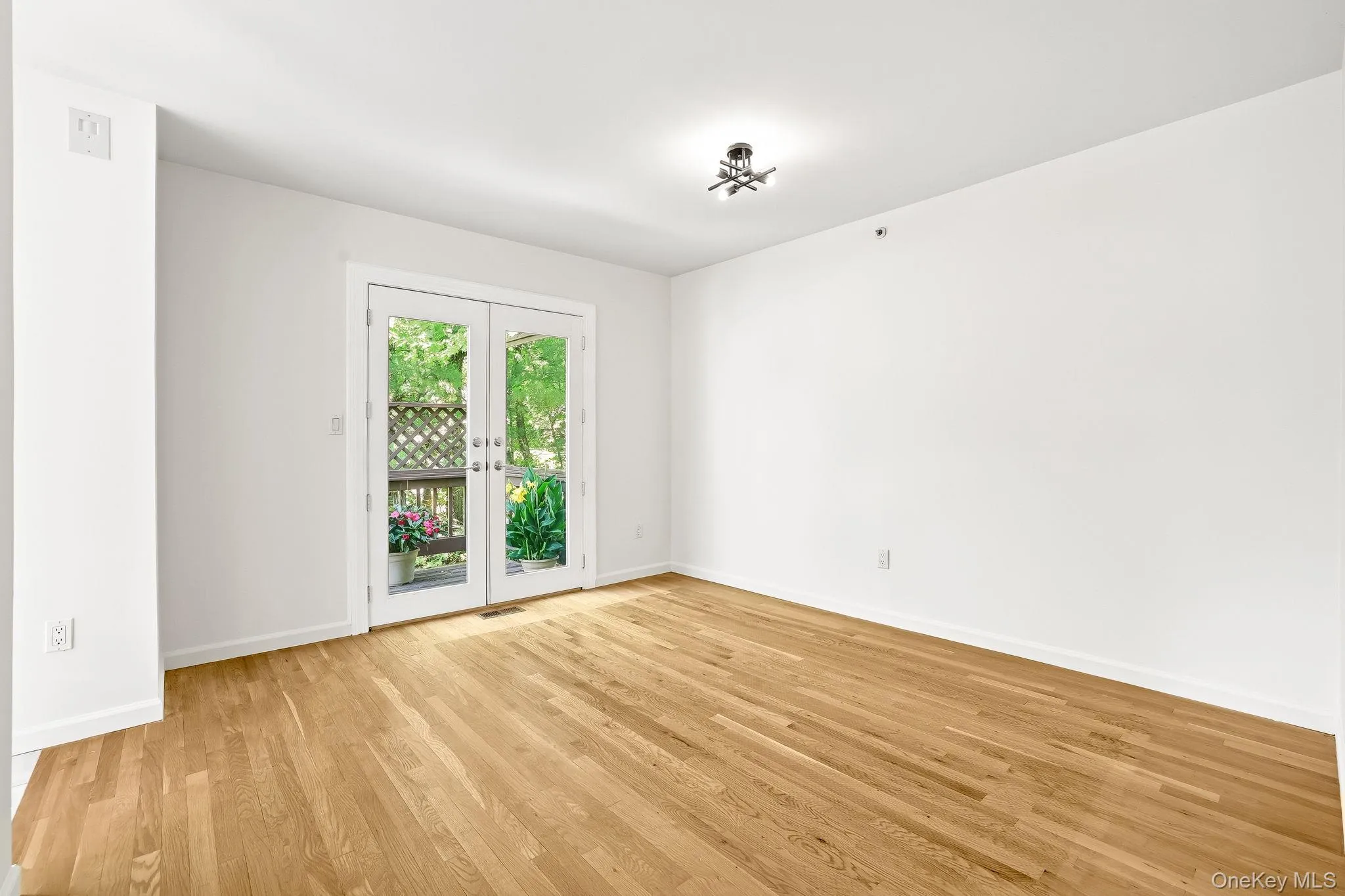 The formal dining room has French doors that open to the raised deck surrounded by blooming plants and overlooking a magnificent Japanese red maple tree The formal dining room has French doors that open to the raised deck surrounded by blooming plants and overlooking a magnificent Japanese red maple tree