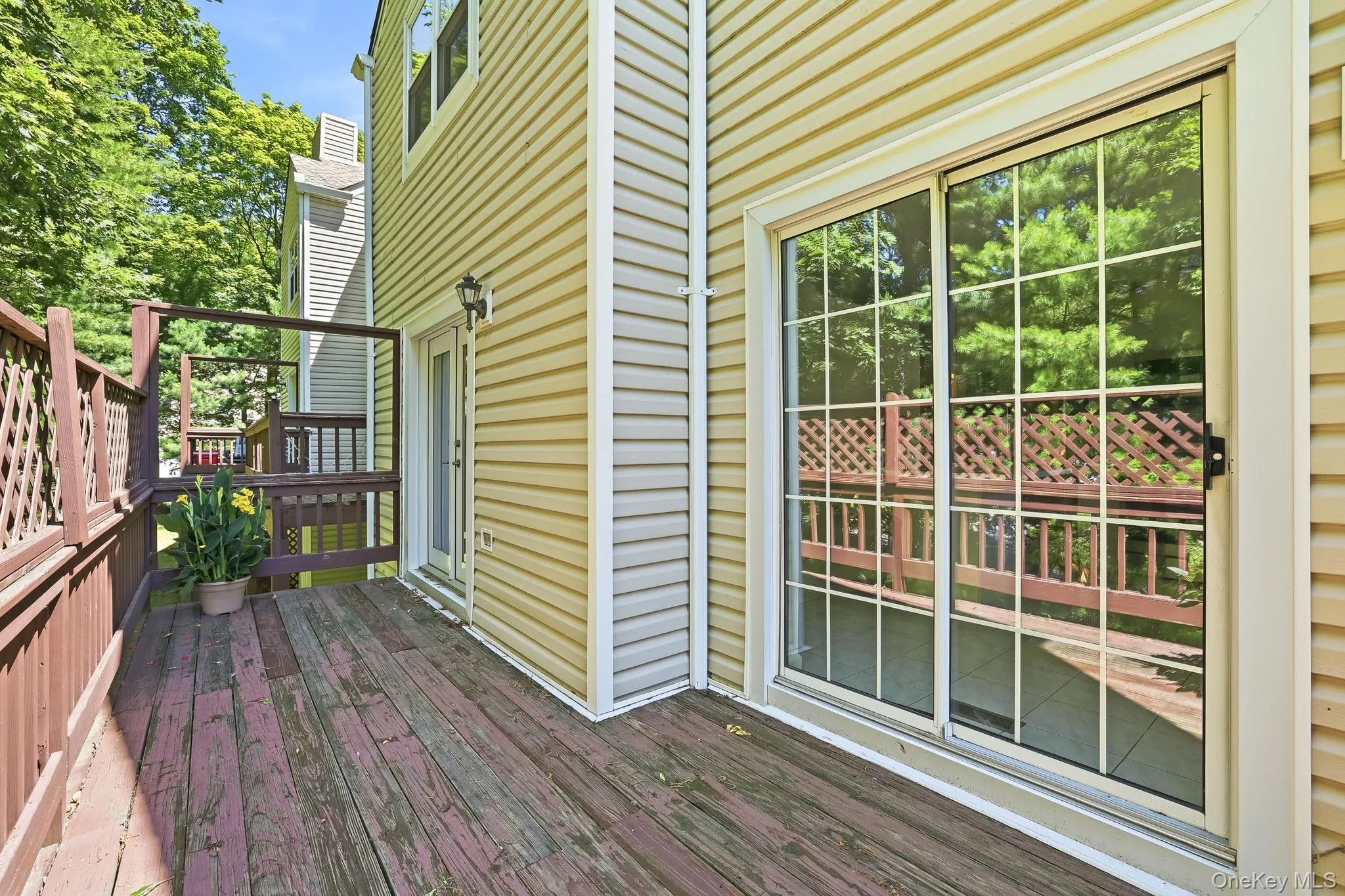 This is the outdoor deck showing the doors into both kitchen and dining room, and can accommodate your table/chairs for outdoor relaxing/dining This is the outdoor deck showing the doors into both kitchen and dining room, and can accommodate your table/chairs for outdoor relaxing/dining
