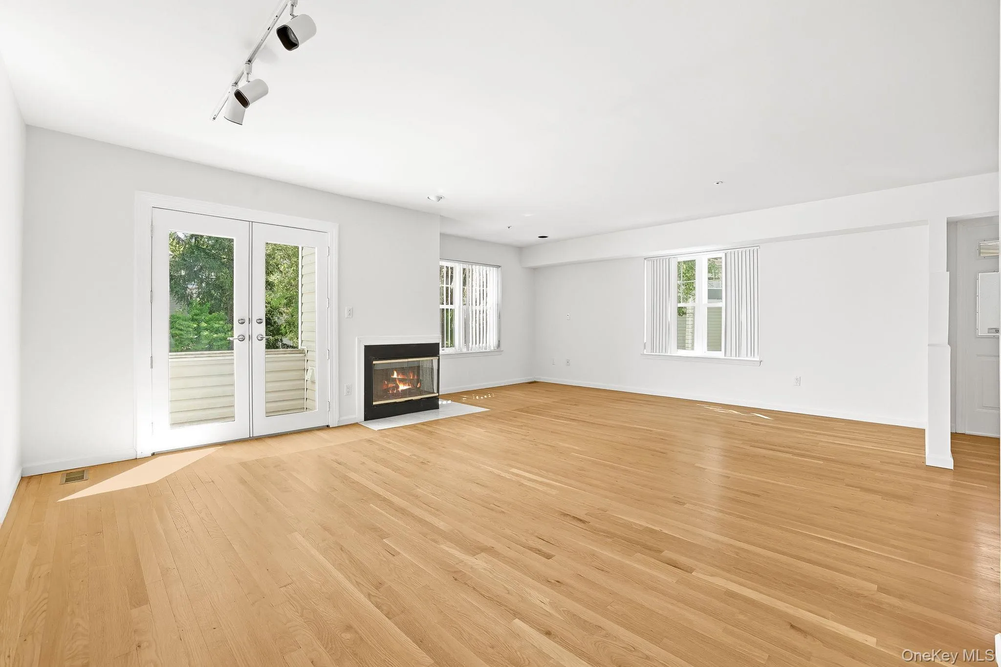 The living room has French doors leading to a small balcony with French doors, overlooking the cul-de-sac The living room has French doors leading to a small balcony with French doors, overlooking the cul-de-sac