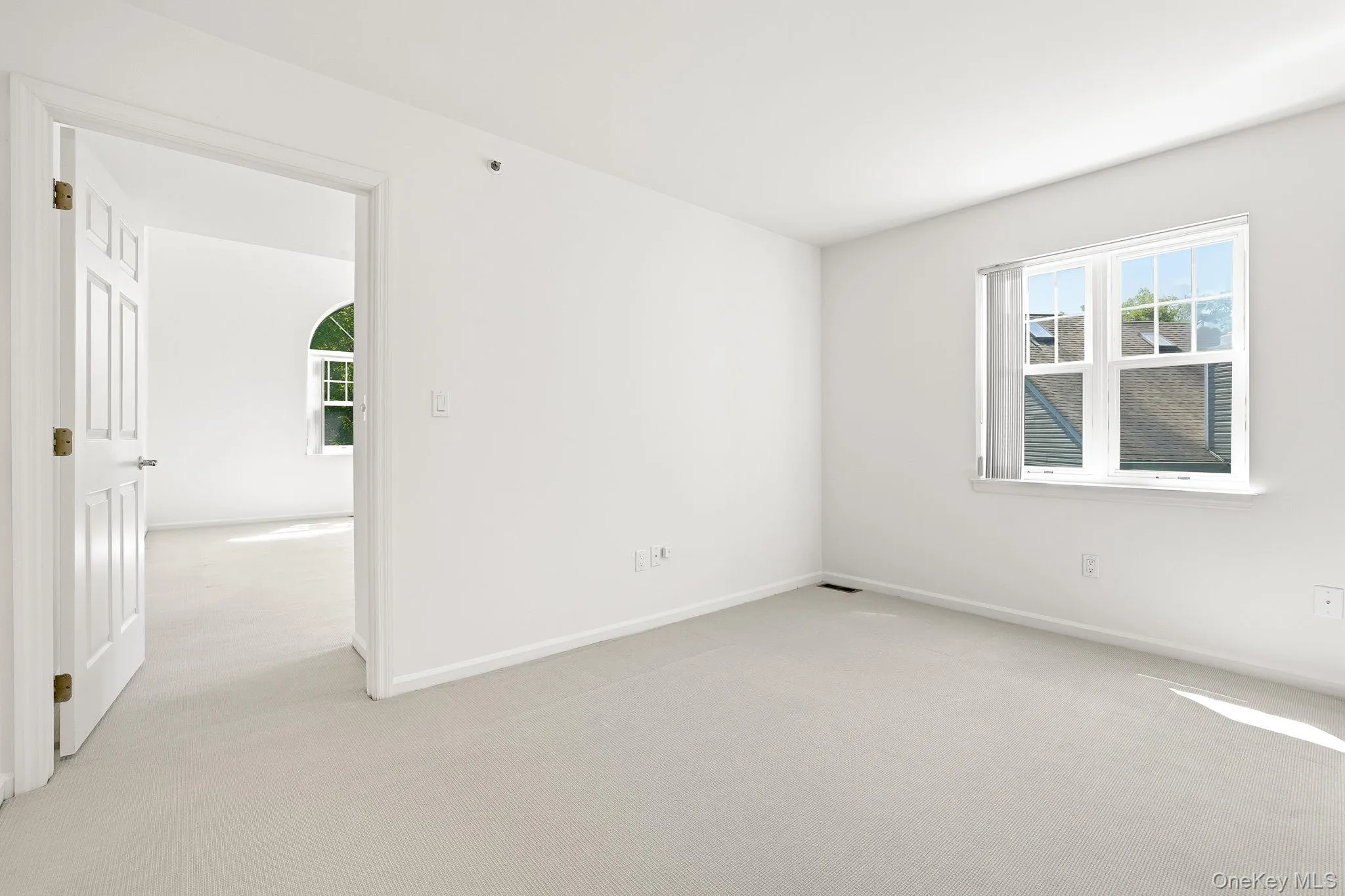Alternate view of the sitting room, with the open door to the primary bedroom Alternate view of the sitting room, with the open door to the primary bedroom